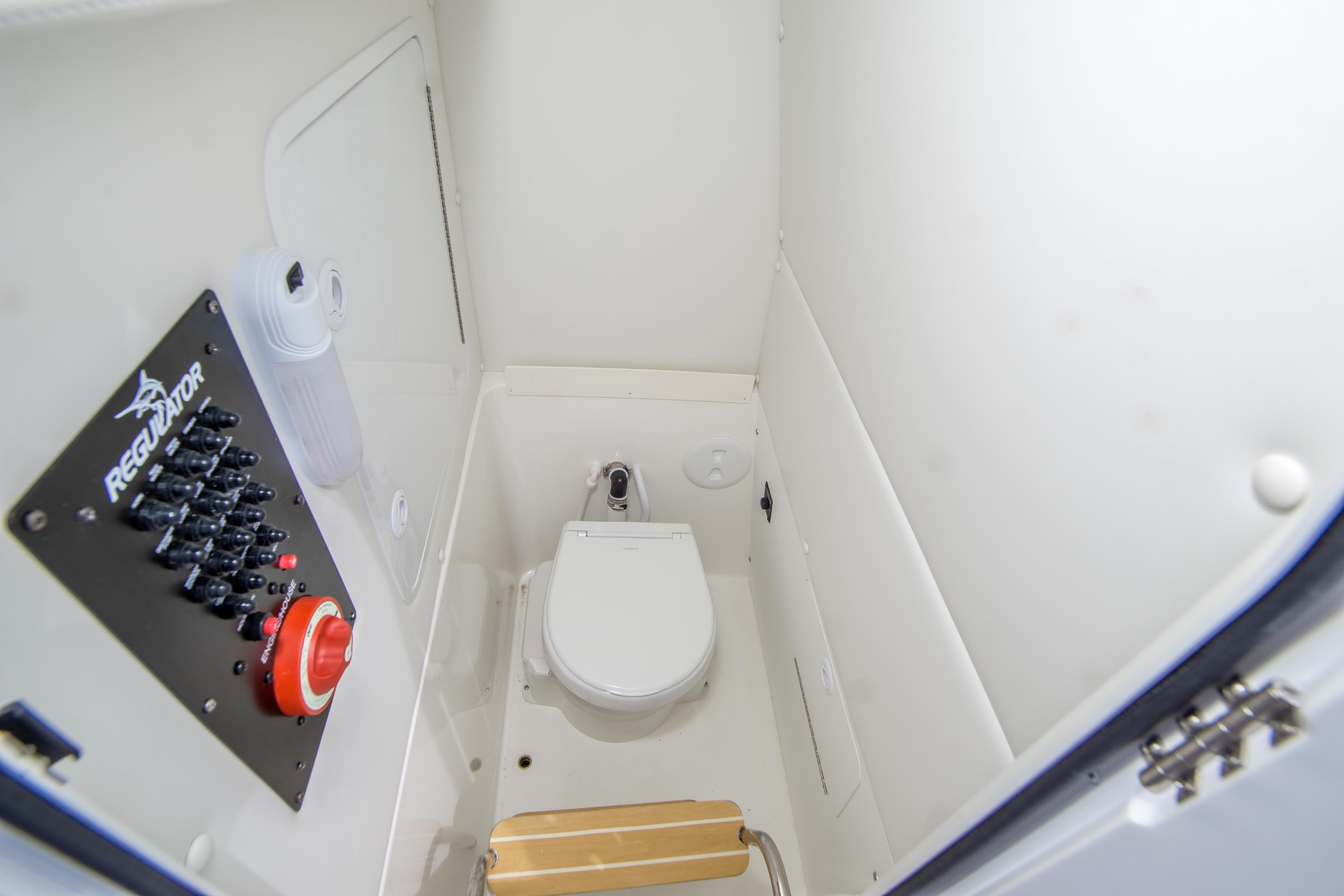 2026 Regulator 23 boat interior with toilet and control panel.