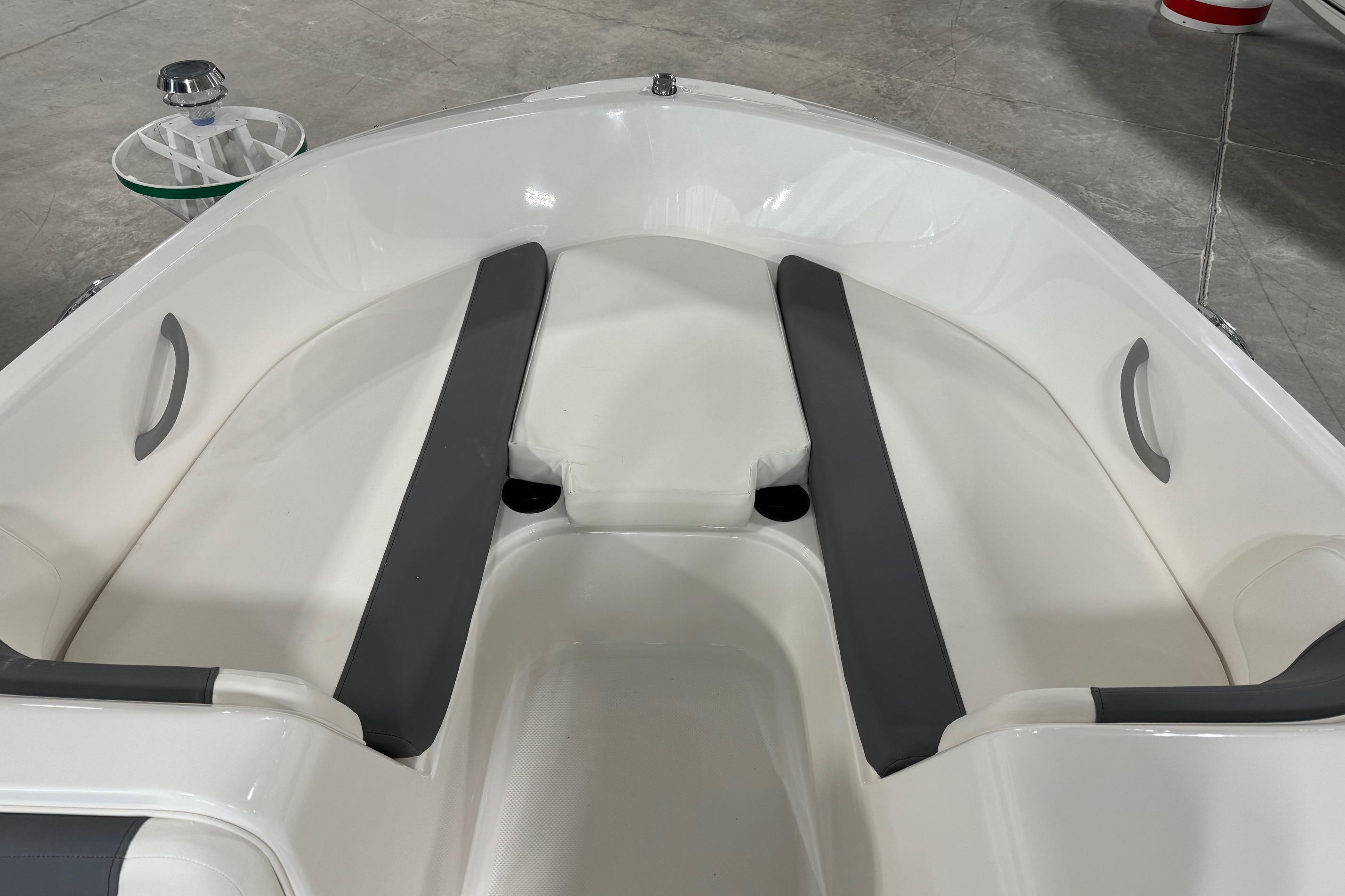 2025 Bayliner Element E18 boat interior with gray seating and white hull.