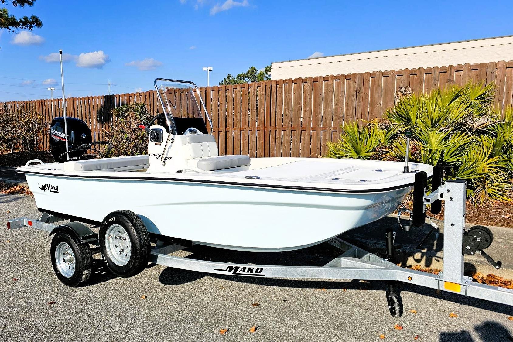 2026 Mako Pro Skiff 13 CC boat on trailer, parked outdoors.