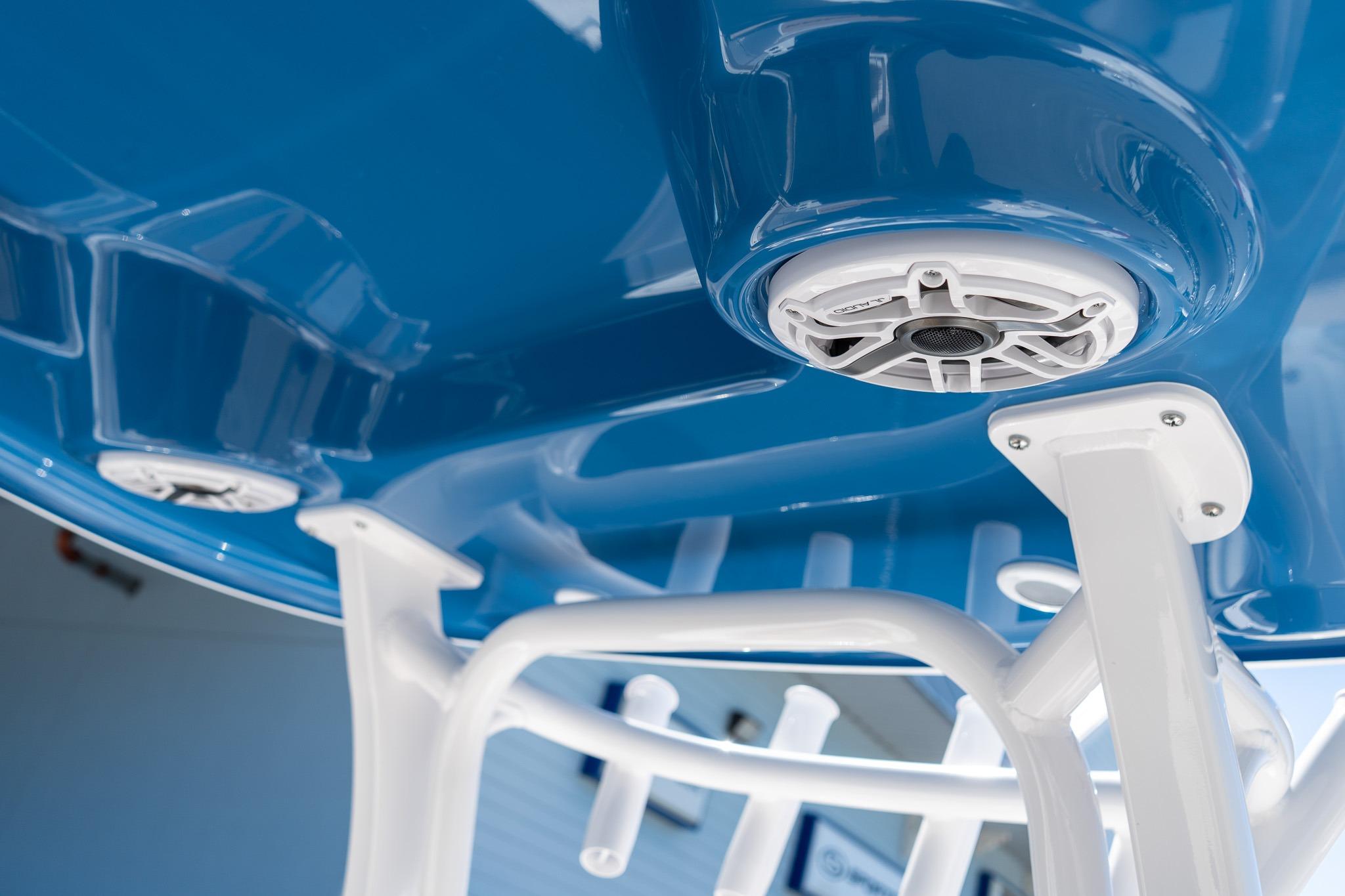 2026 Sportsman Open 282 Center Console, blue hull with white speaker and support structure.
