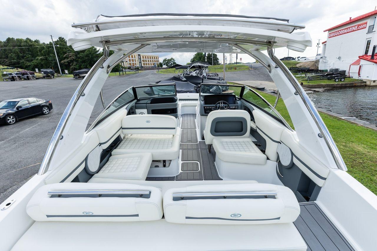 2021 Cobalt R30 boat with luxurious seating and sleek design at a marina.