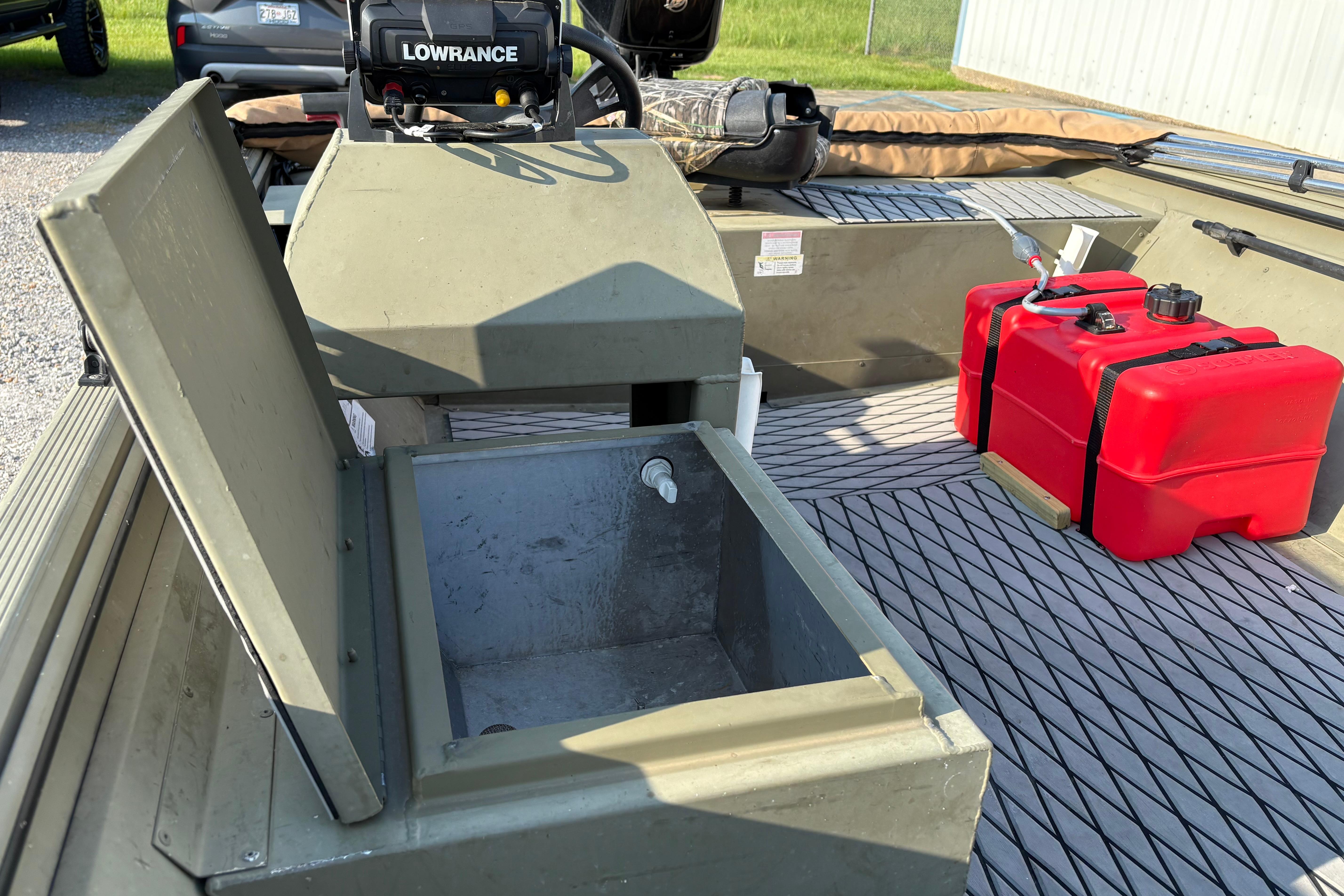 2019 Lowe Roughneck 1860SC boat interior with storage compartment and red fuel tank.