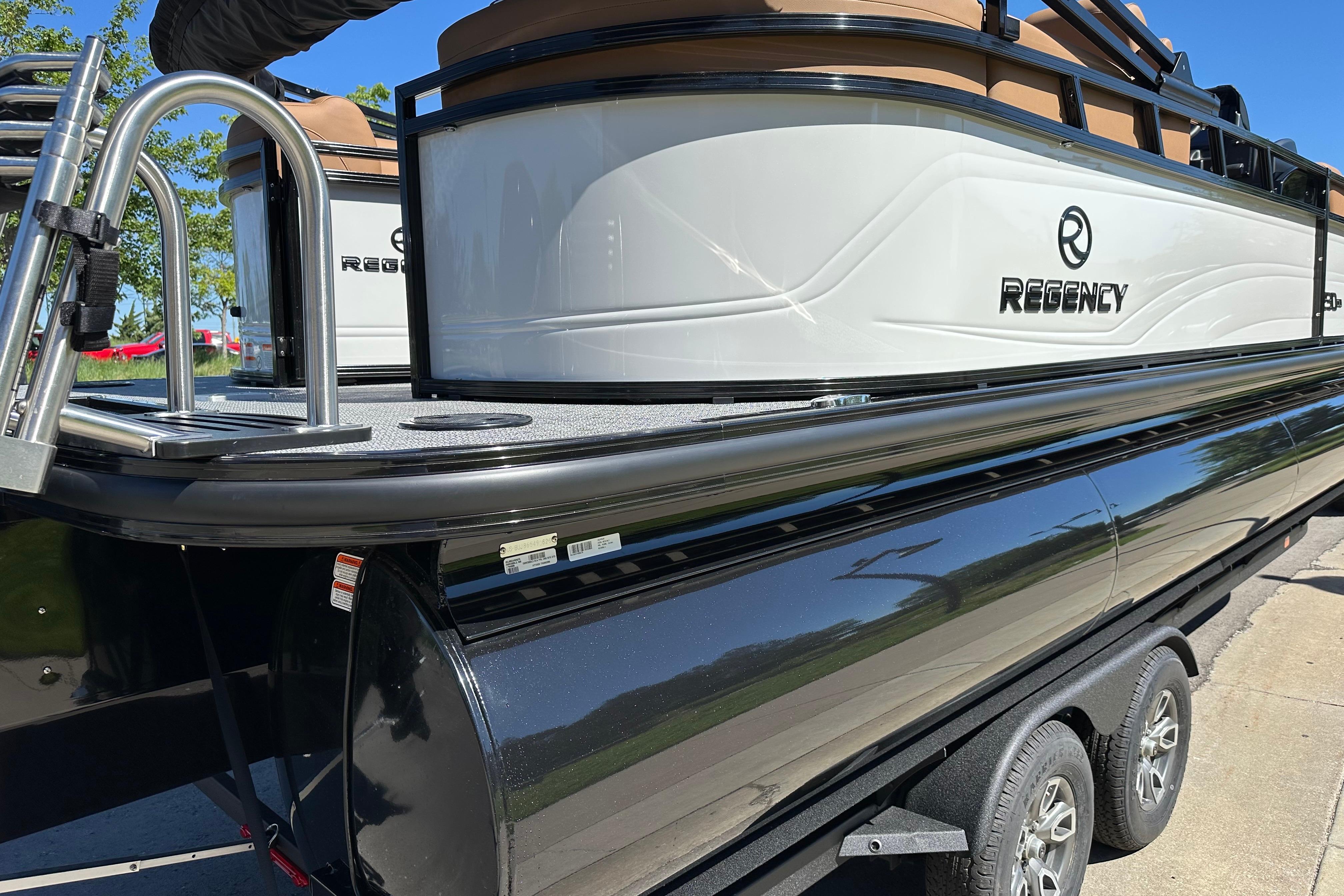 2026 Regency 230 DL pontoon boat on trailer, showcasing sleek design and modern features.