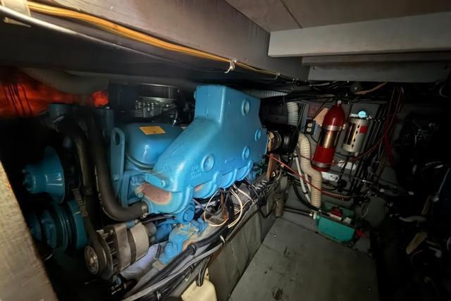 Engine room of 1980 Chris-Craft 381 Catalina, showcasing mechanical components and wiring.