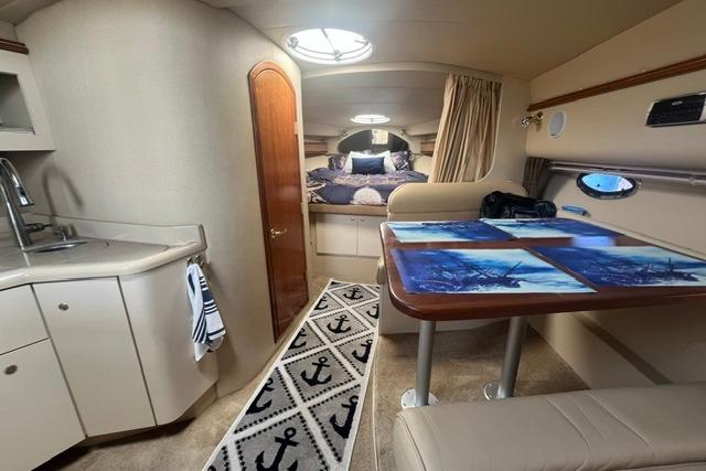 2004 Cruisers Yachts 3372 Express cabin interior with kitchenette and dining area.
