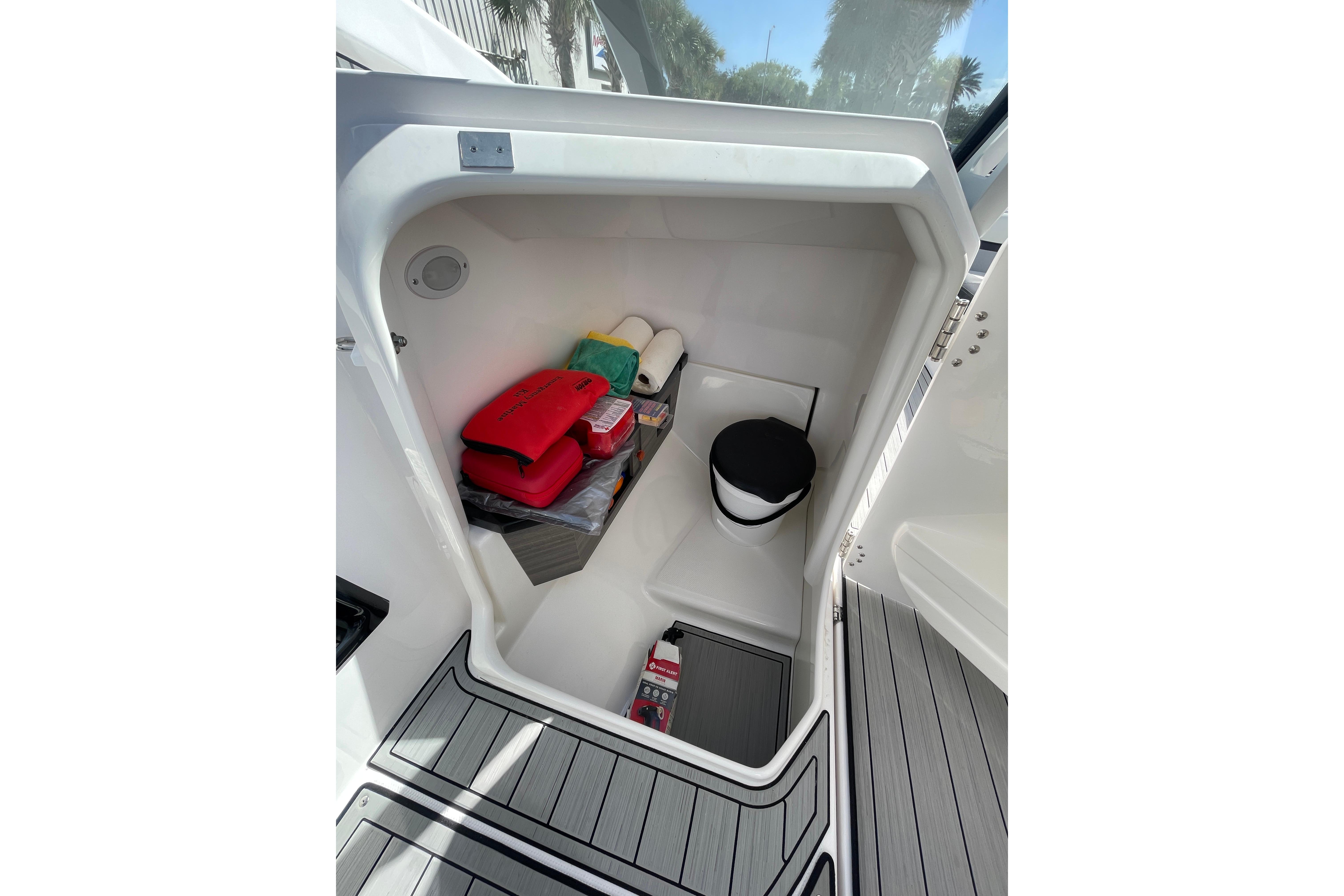 2021 Yamaha Boats 275SE storage compartment with safety gear and accessories.