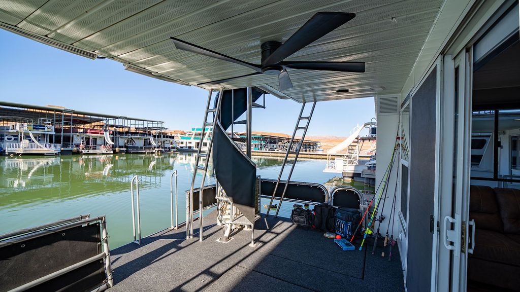 1999 Sumerset Widebody houseboat with deck and lake view.