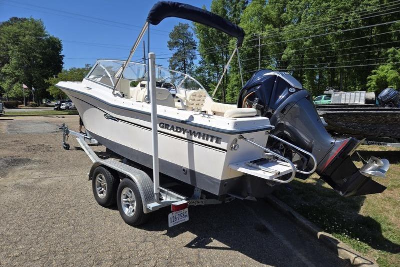 2007 Grady-White Tournament 205 boat on trailer, parked outdoors, with outboard motor.