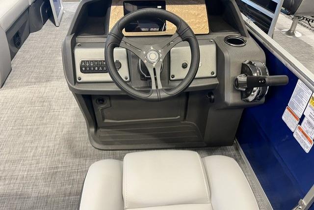 2026 Sun Tracker Party Barge 20 DLX helm with steering wheel and control panel.