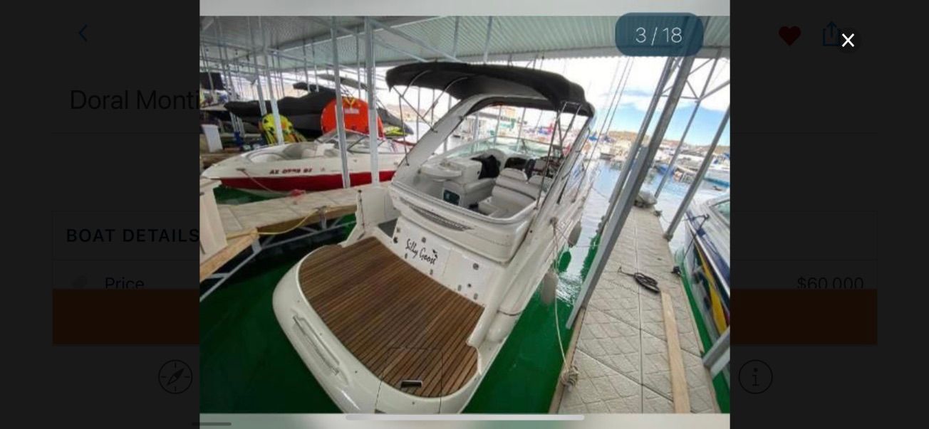 A 2007 Doral Monticello boat docked in a covered marina. It features a spacious deck.