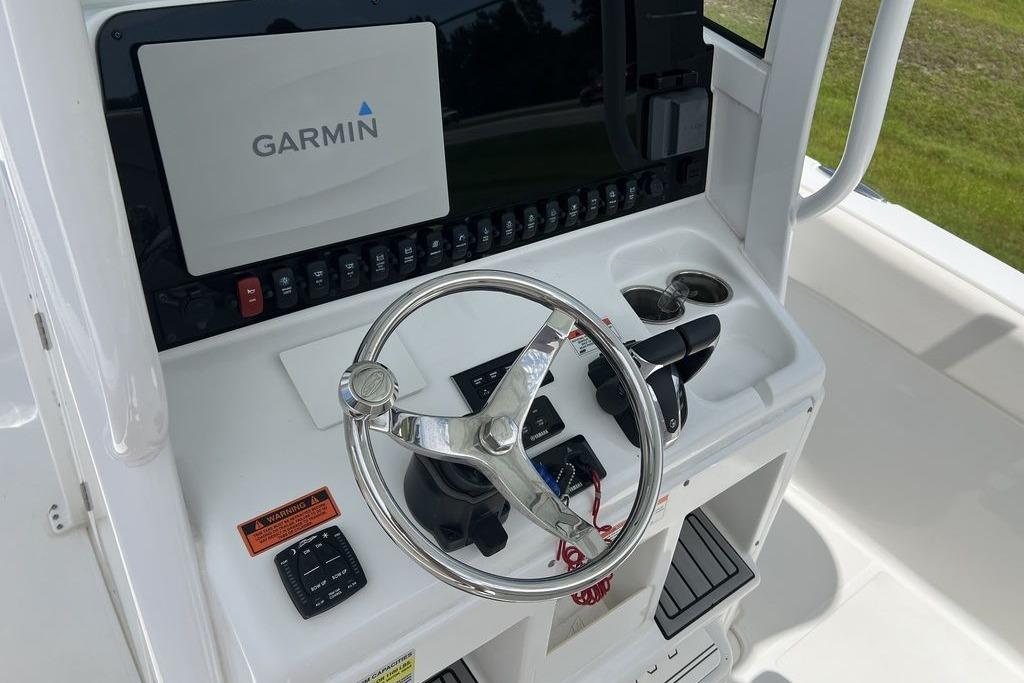 2021 Sea Hunt Gamefish 25 helm with Garmin display and steering wheel.