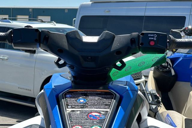 Close-up of a Yamaha WaveRunner Jetblaster's handlebars, surrounded by vehicles.