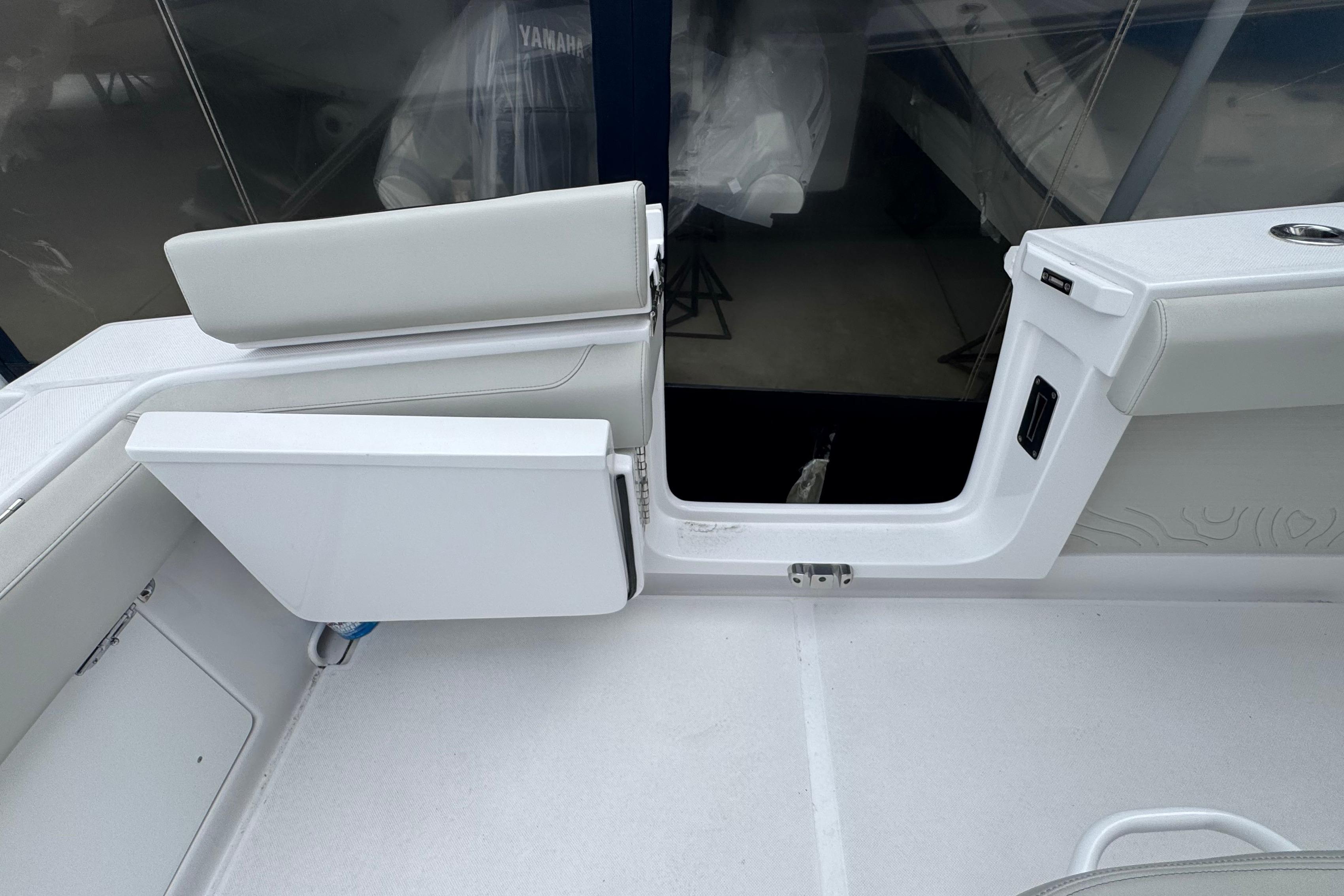 Interior view of a 2026 Jupiter 30 boat, featuring sleek white seating and modern design.