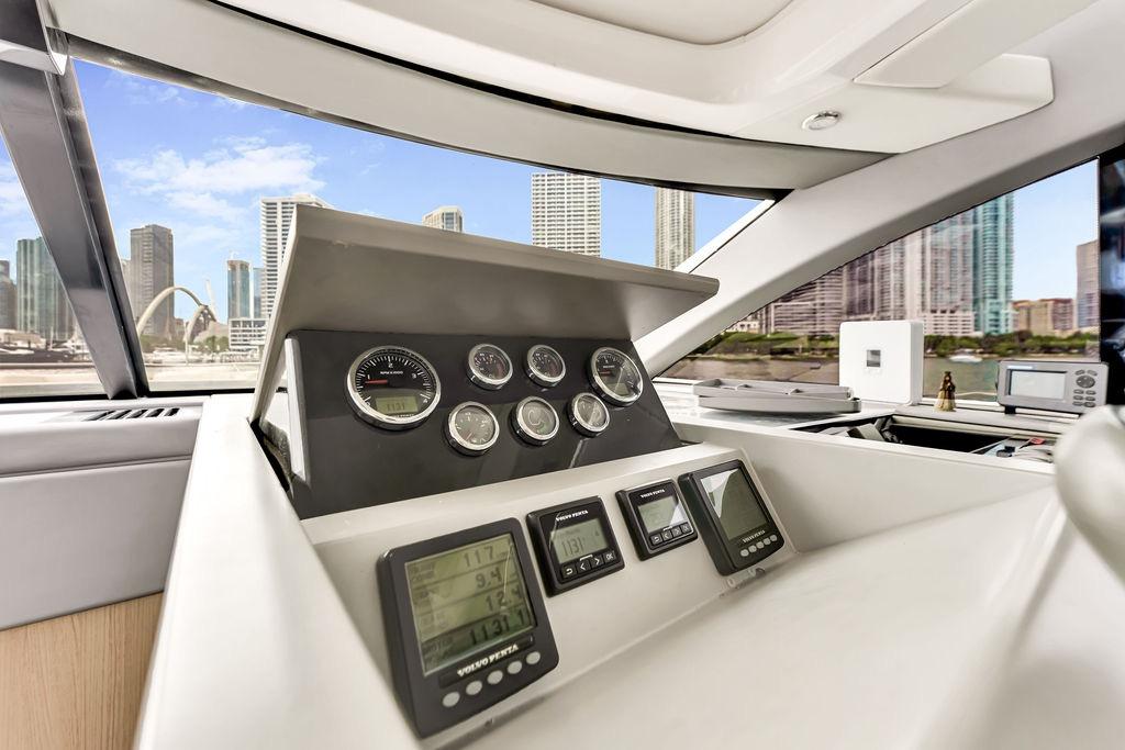 Interior view of 2012 Fairline Targa 58 yacht dashboard with city skyline background.
