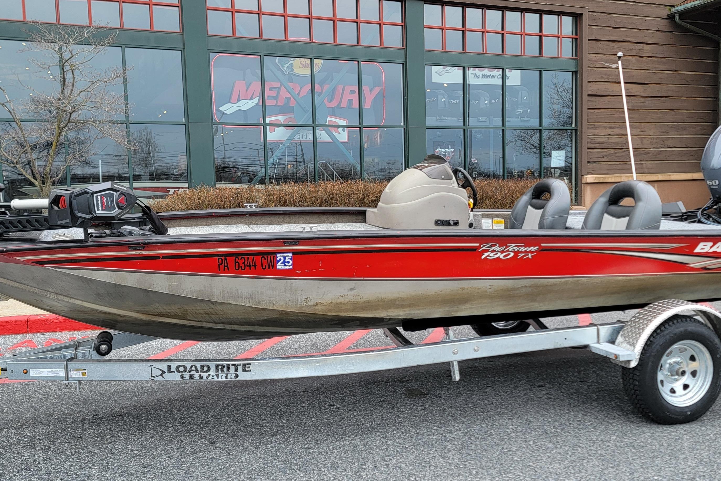 2006 Tracker Pro Team 190 TX boat on Load Rite trailer outside a store.