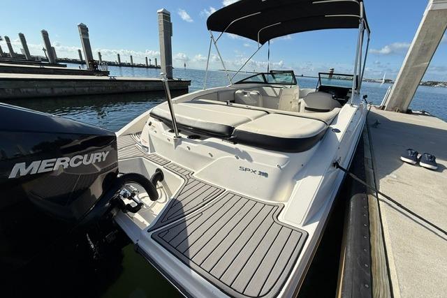 2022 Sea Ray SPX 210 Outboard boat docked, featuring a Mercury engine and spacious seating.