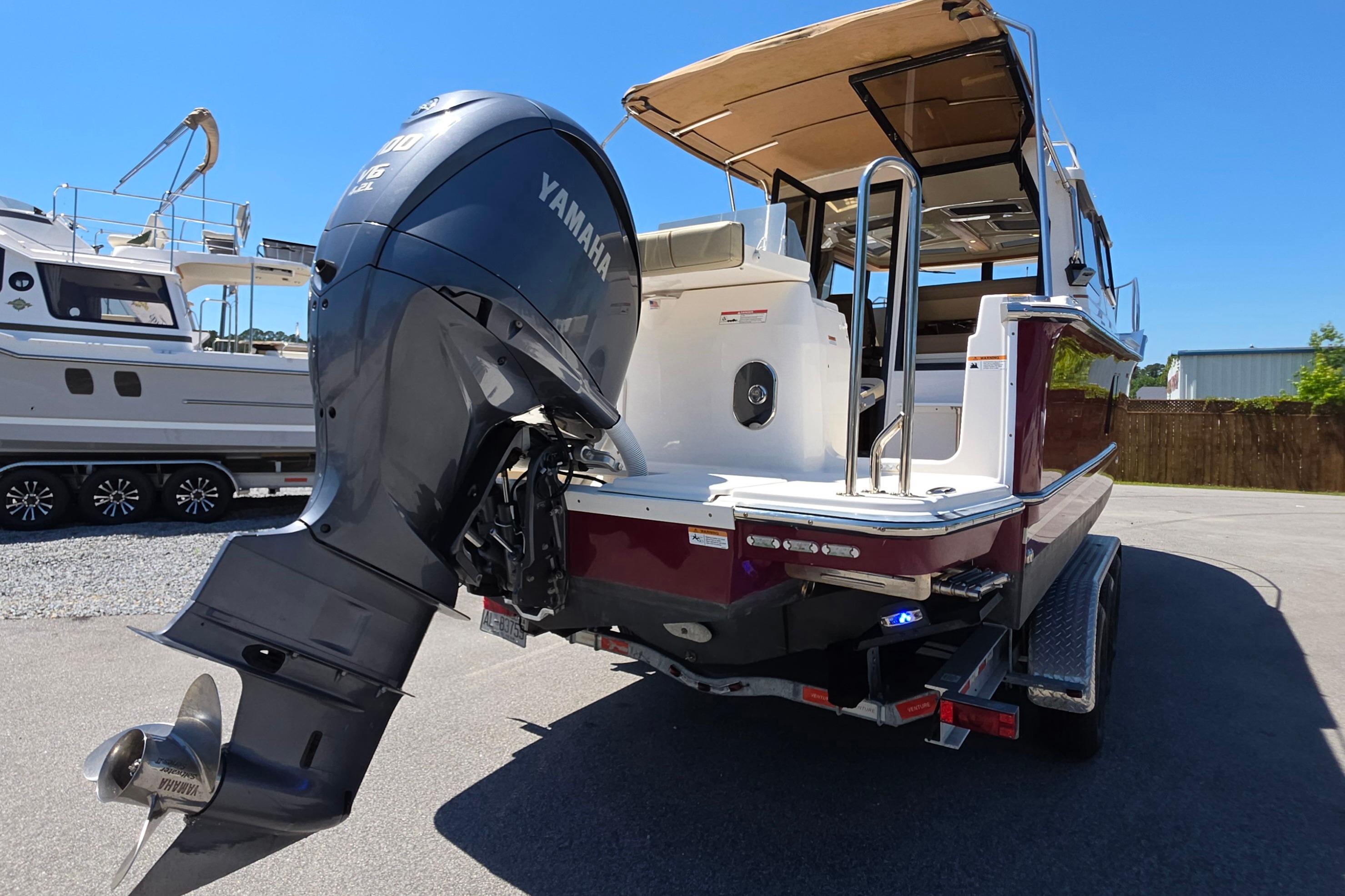 2021 Ranger Tug R27 with Yamaha outboard motor, parked on a trailer.