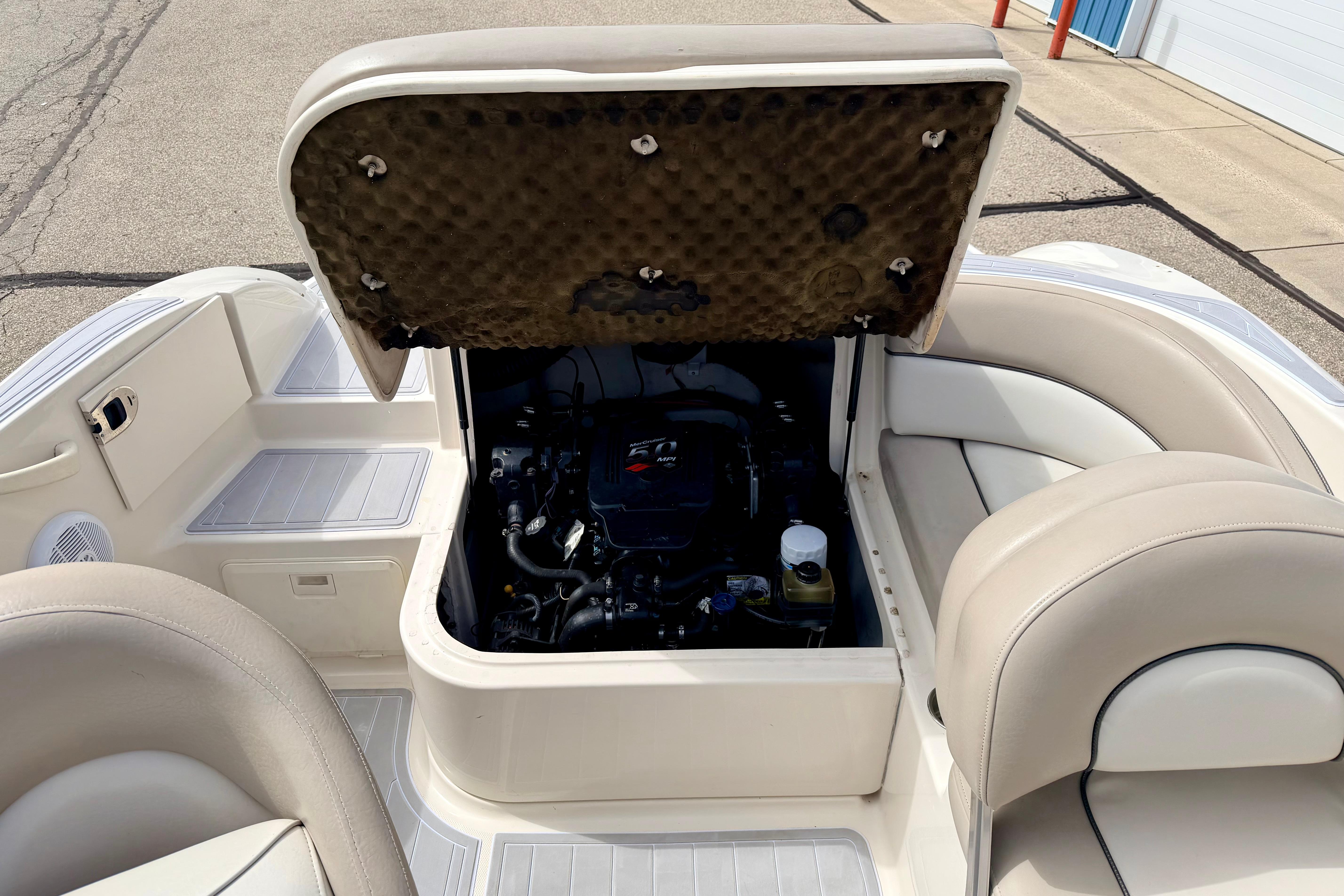 2003 Sea Ray 200 Sundeck boat engine compartment with open hatch, showcasing interior details.