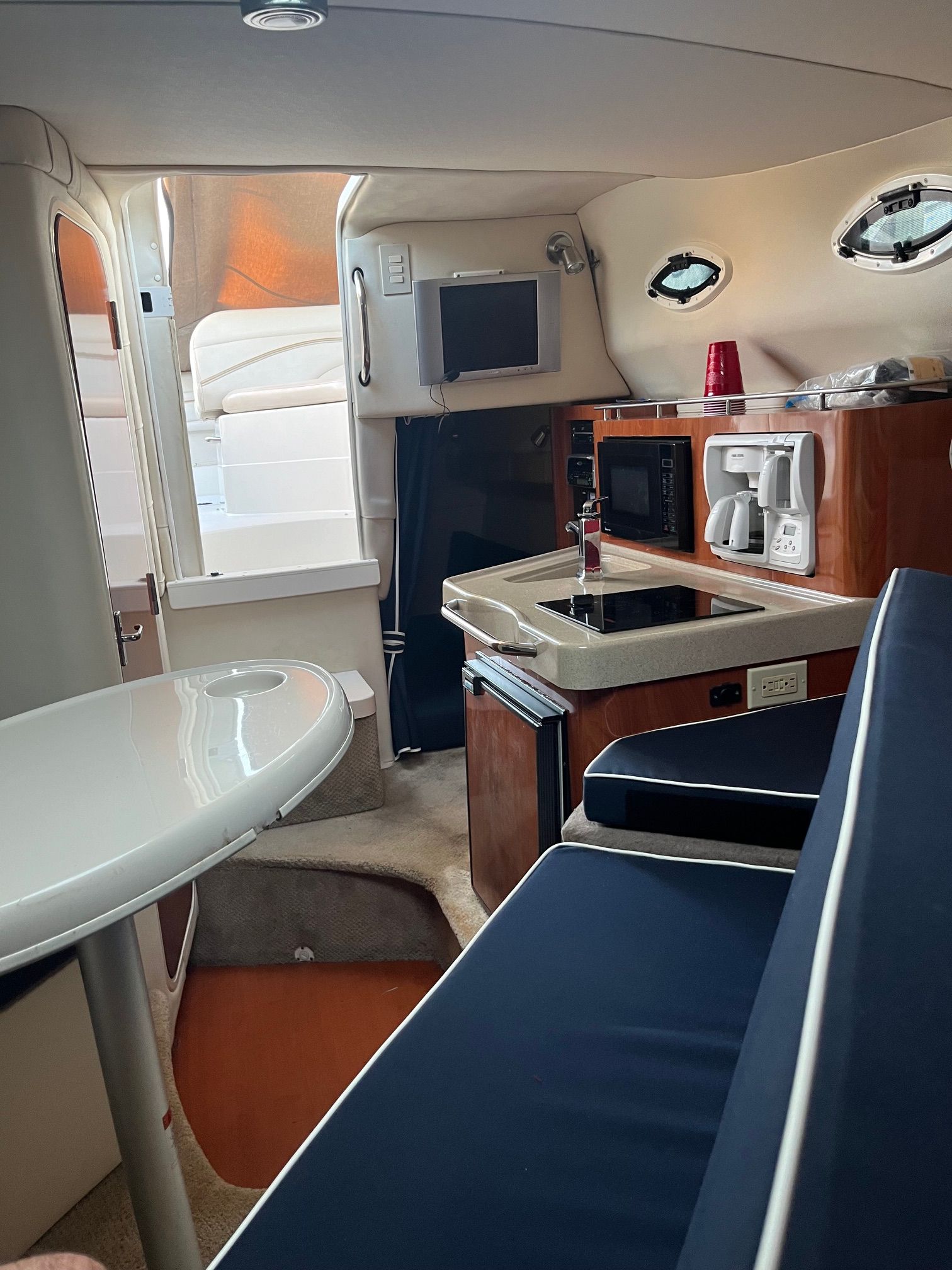 Interior of a 2004 Larson Cabriole yacht with kitchen and seating area.
