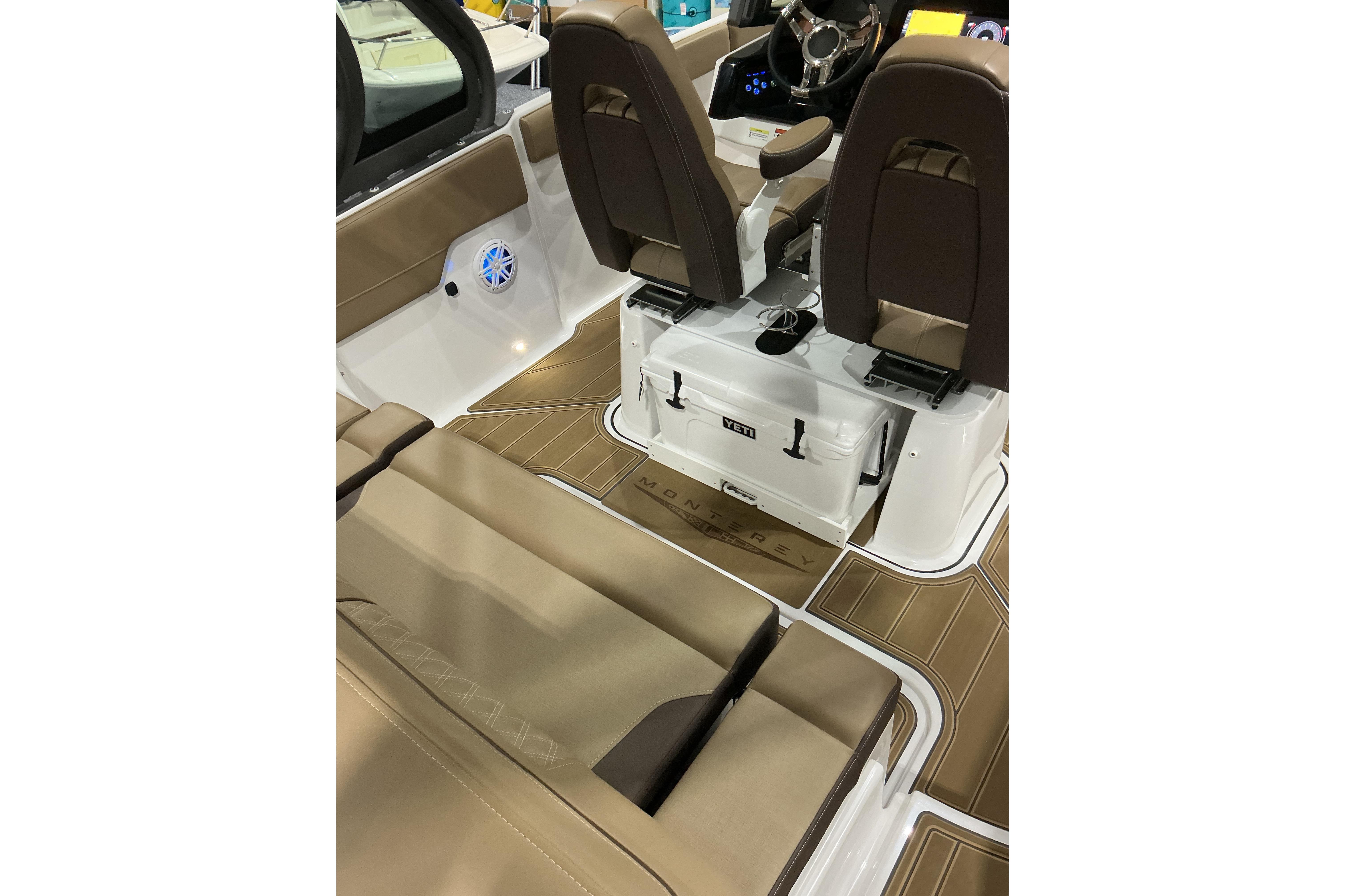 2026 Monterey Elite 25 SD boat interior with brown seating and Yeti cooler.