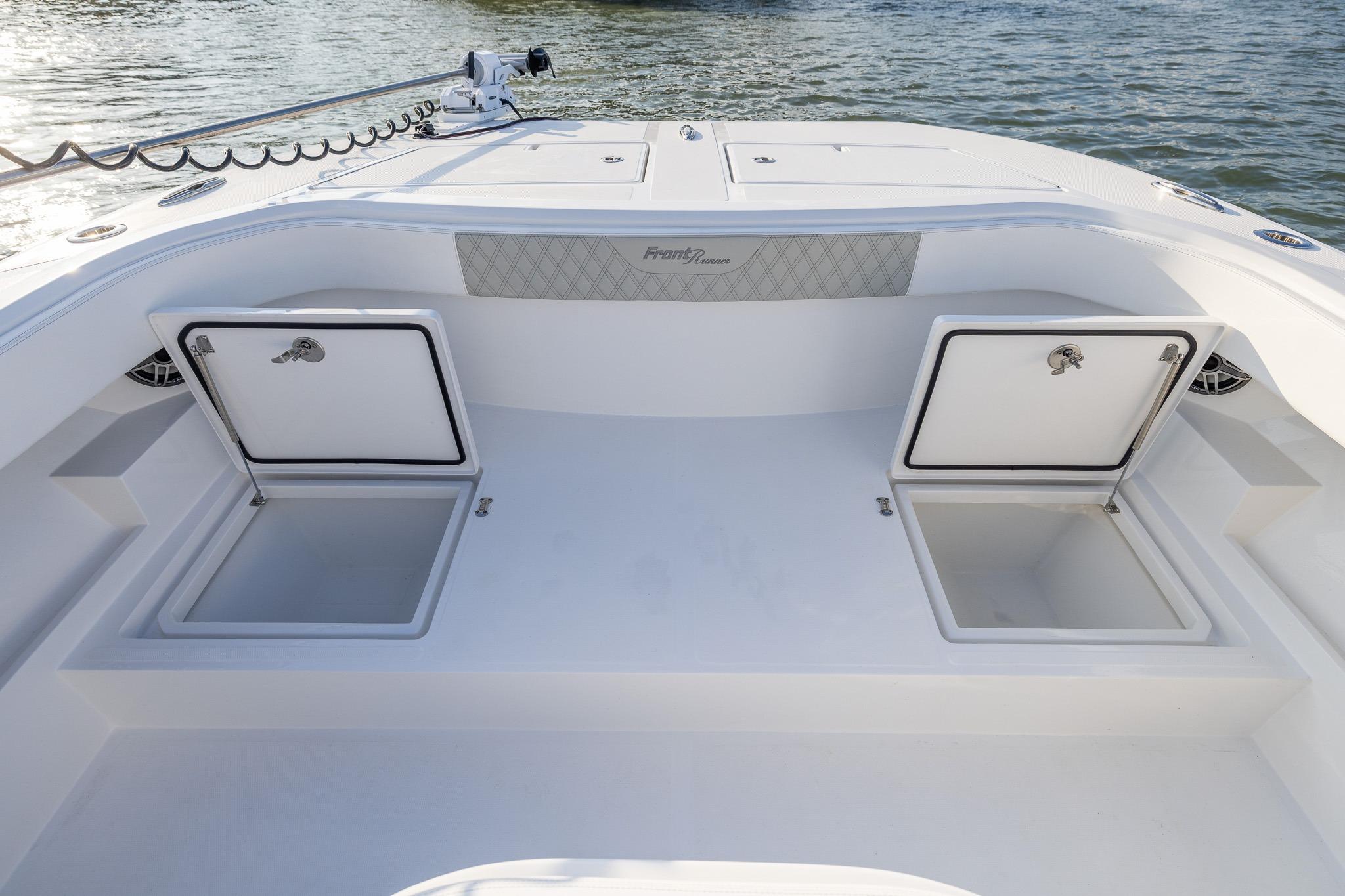 2026 Front Runner 37 Catamaran deck with open storage compartments on calm water.