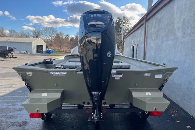 2026 Tracker Grizzly 2072 CC boat with powerful outboard motor, parked outdoors.