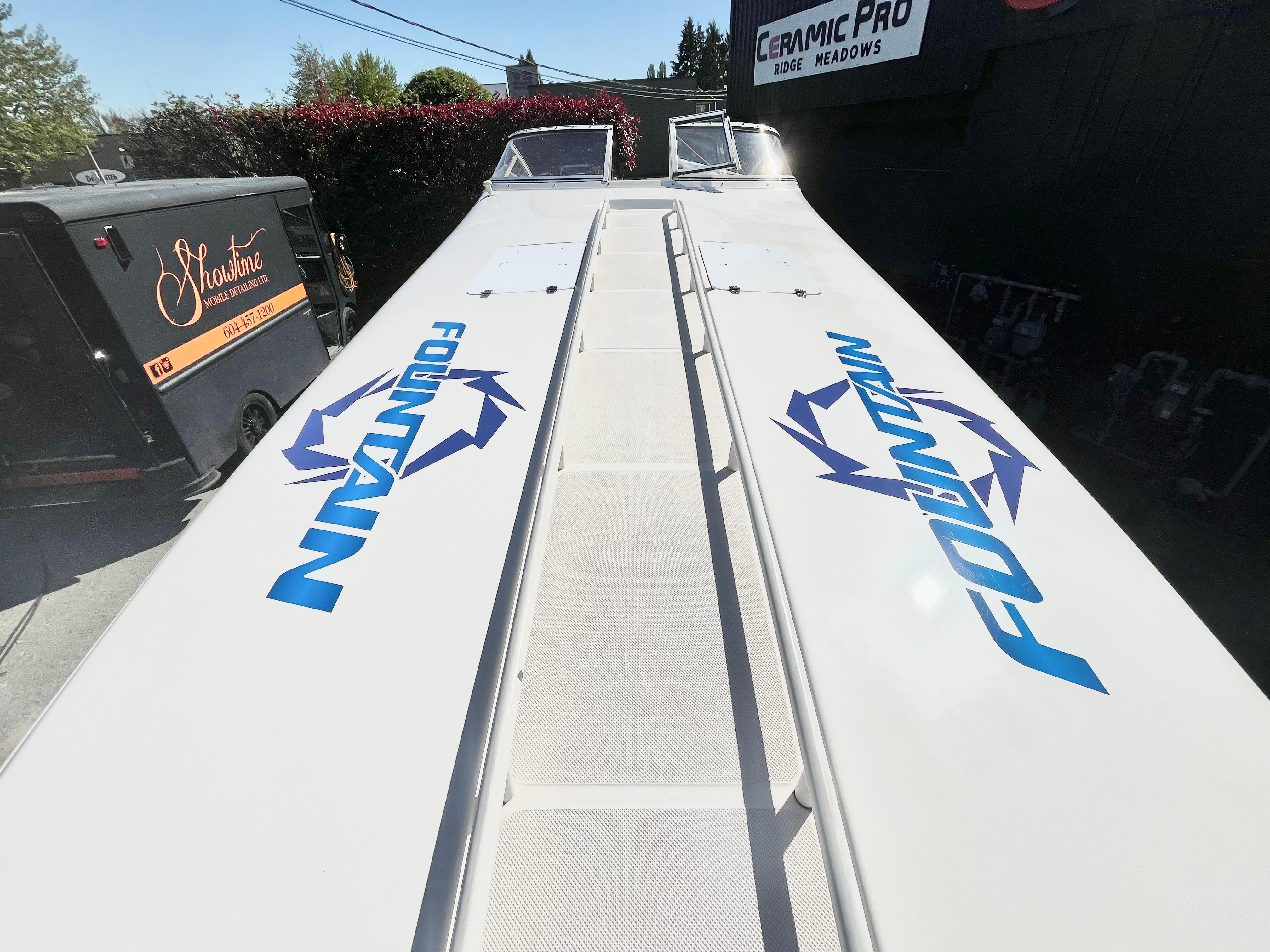 1999 Fountain 38 Sport Cruiser boat with logo, parked outdoors.
