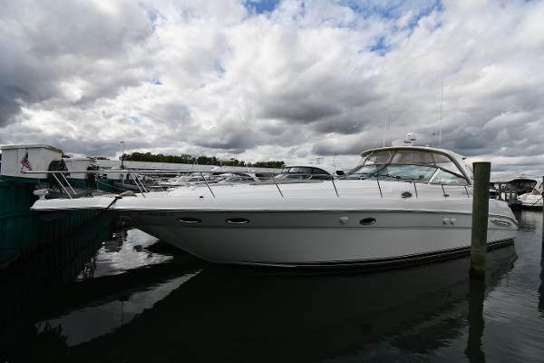 2003 Sea Ray 460 Sundancer yacht docked under cloudy skies.