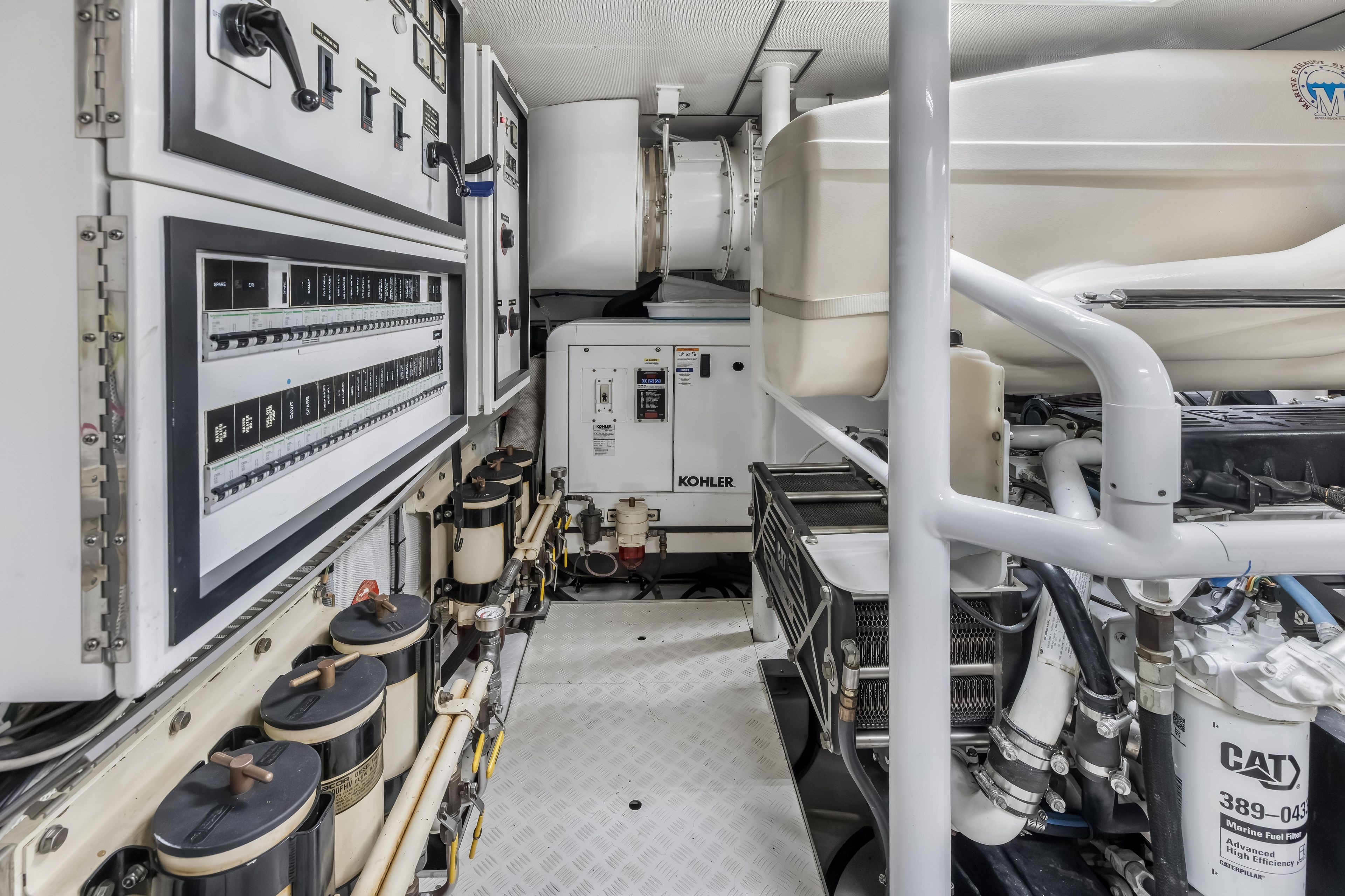 Engine room of 2012 Cheoy Lee 84 Bravo yacht with Kohler generator and control panels.