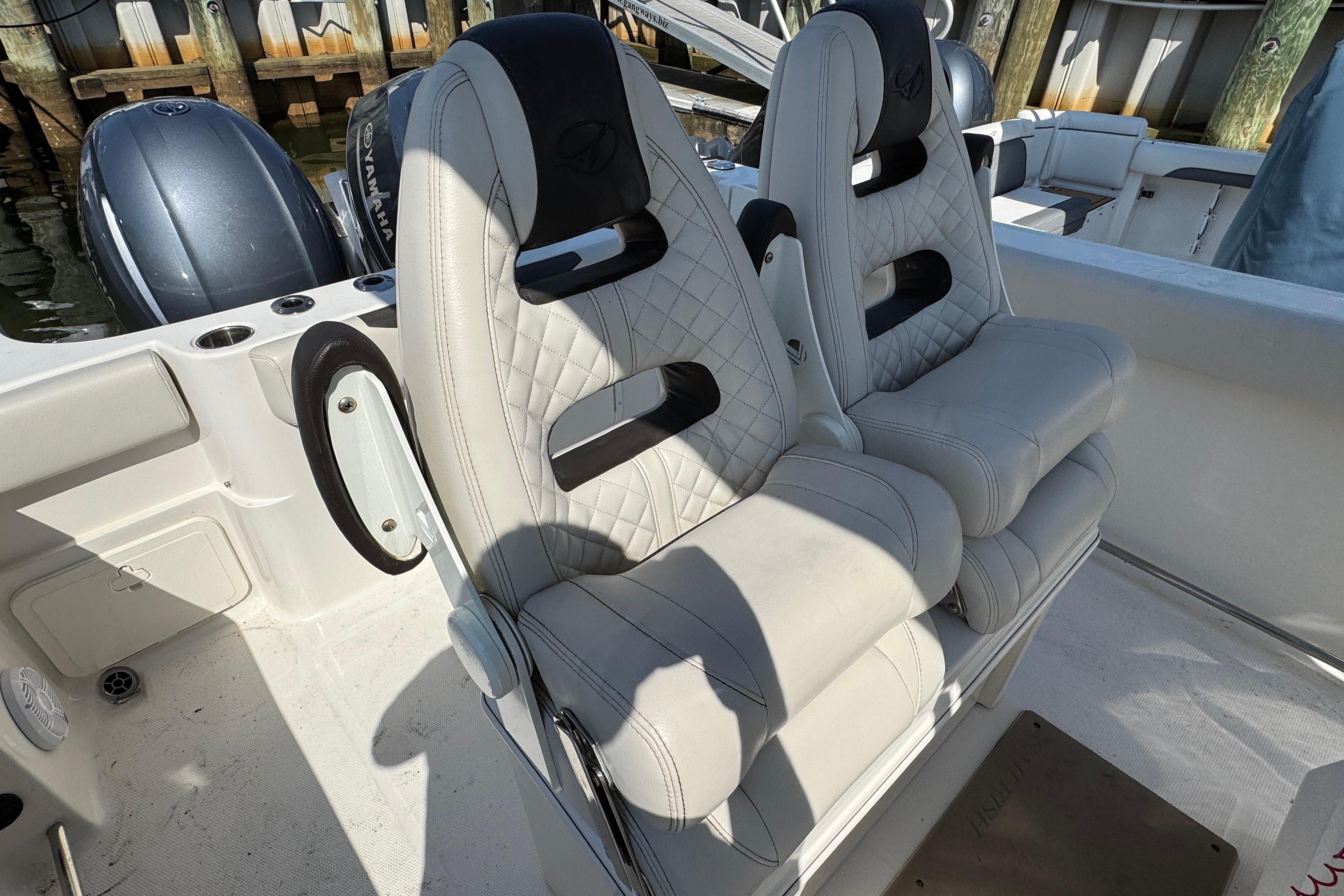 Luxury seating on 2022 Sailfish 242 CC boat with dual Yamaha engines.