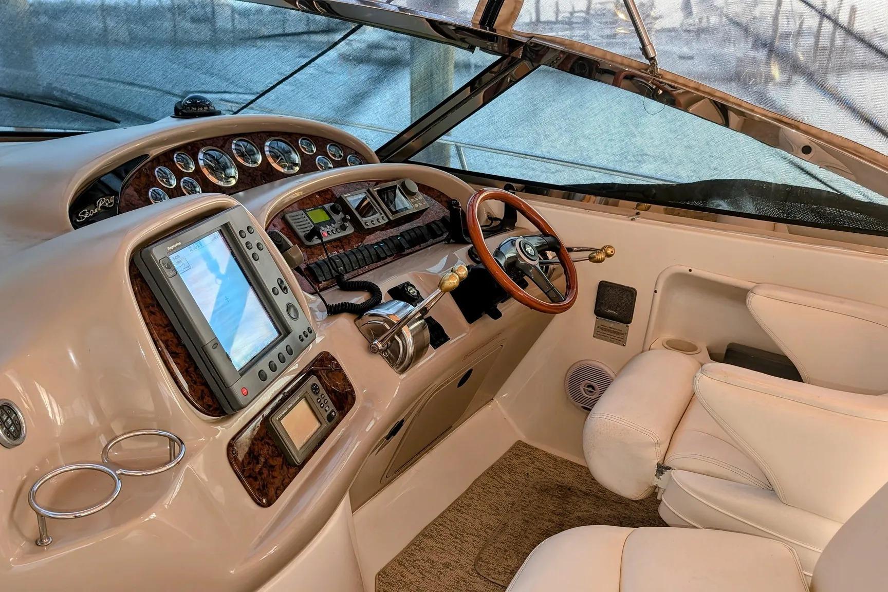 Cockpit of 2000 Sea Ray 380 Sundancer with navigation equipment and leather seating.