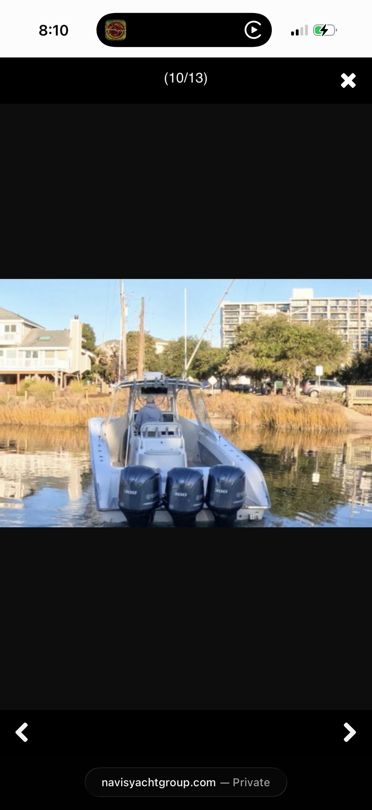 Rear view of a Cape Horn 36T boat with three outboard motors, situated in calm waters.