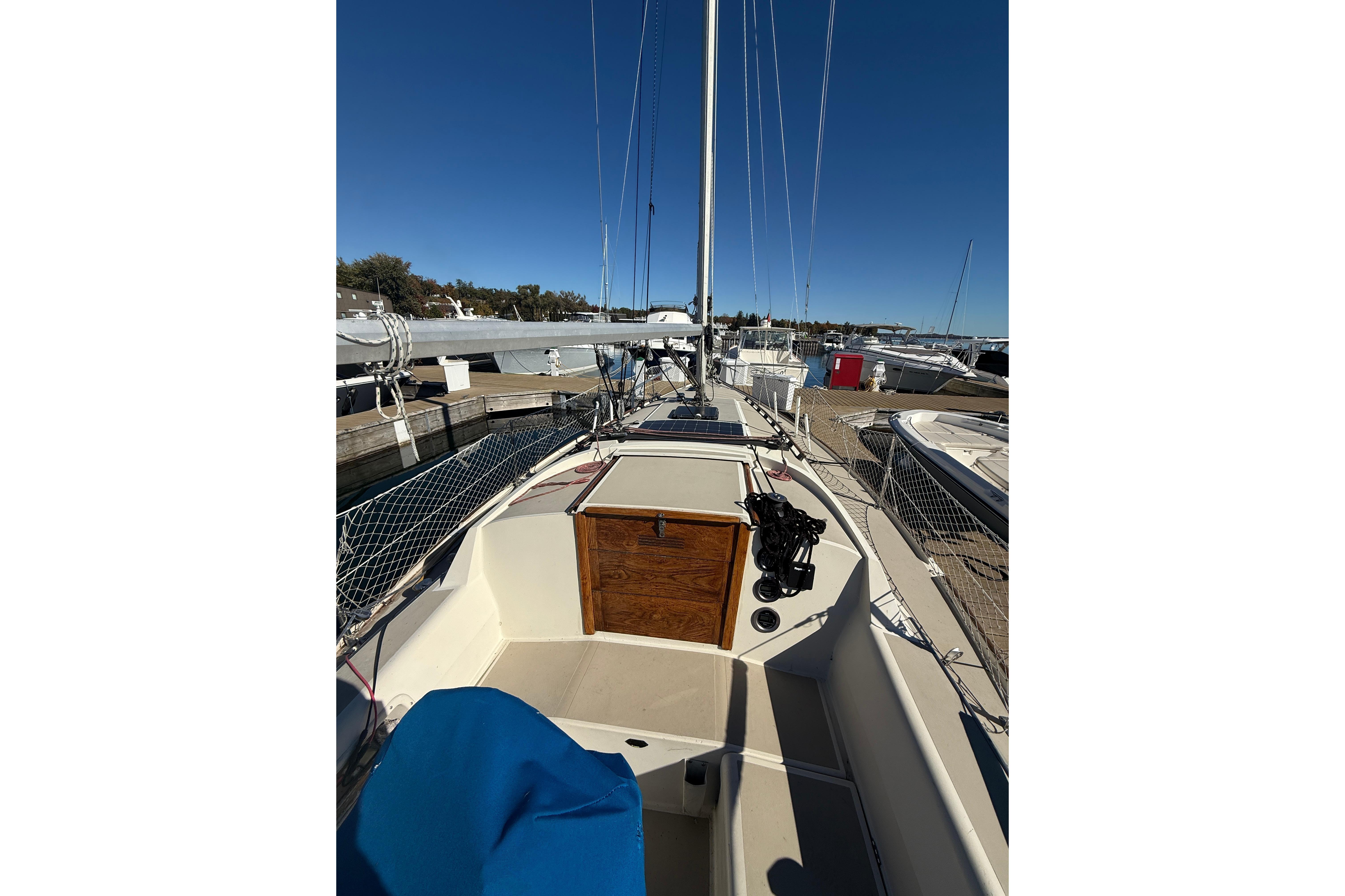 1983 O'Day 34 sailboat docked, showcasing deck and rigging under clear blue sky.