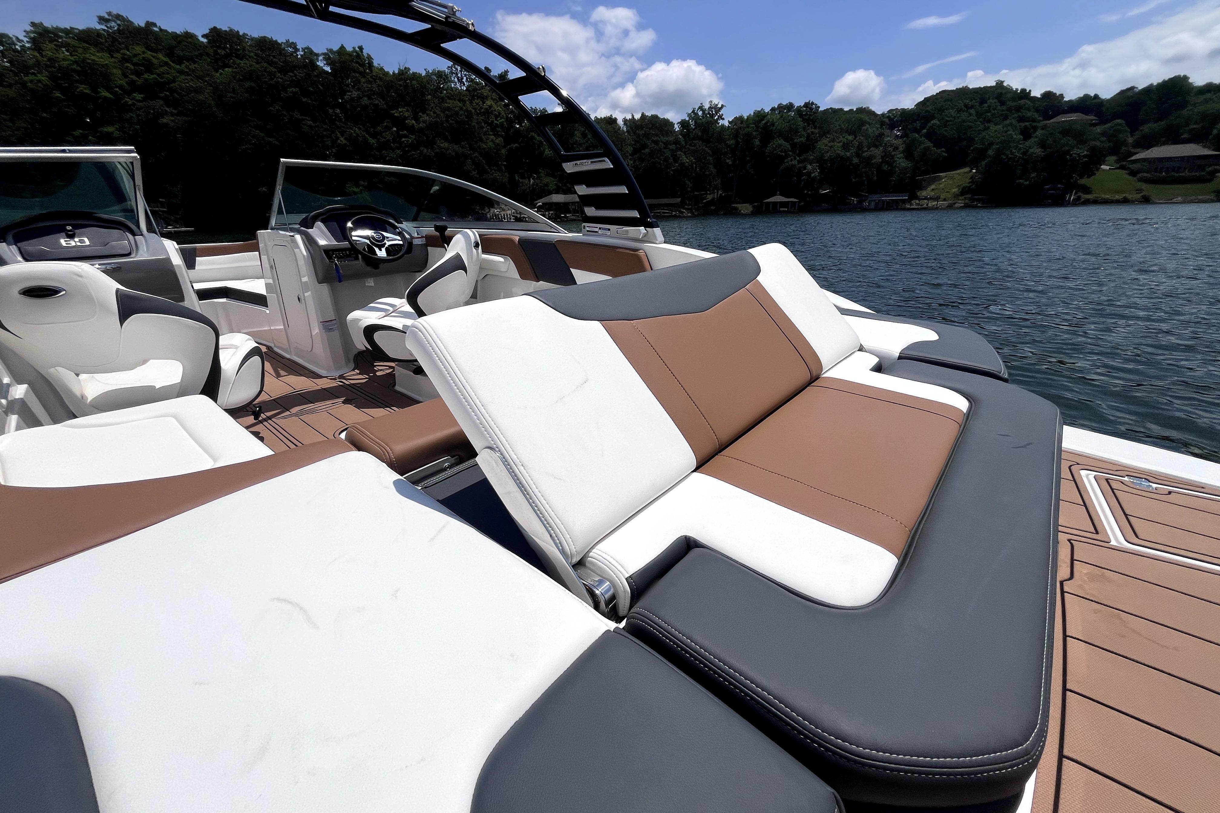 2025 Chaparral 230 SSi boat interior with luxurious seating on a serene lake.