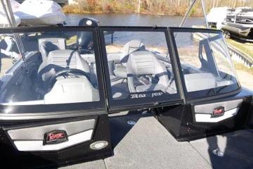 2026 Ranger 2080MS boat interior with gray seating and windshield, docked by a lake.