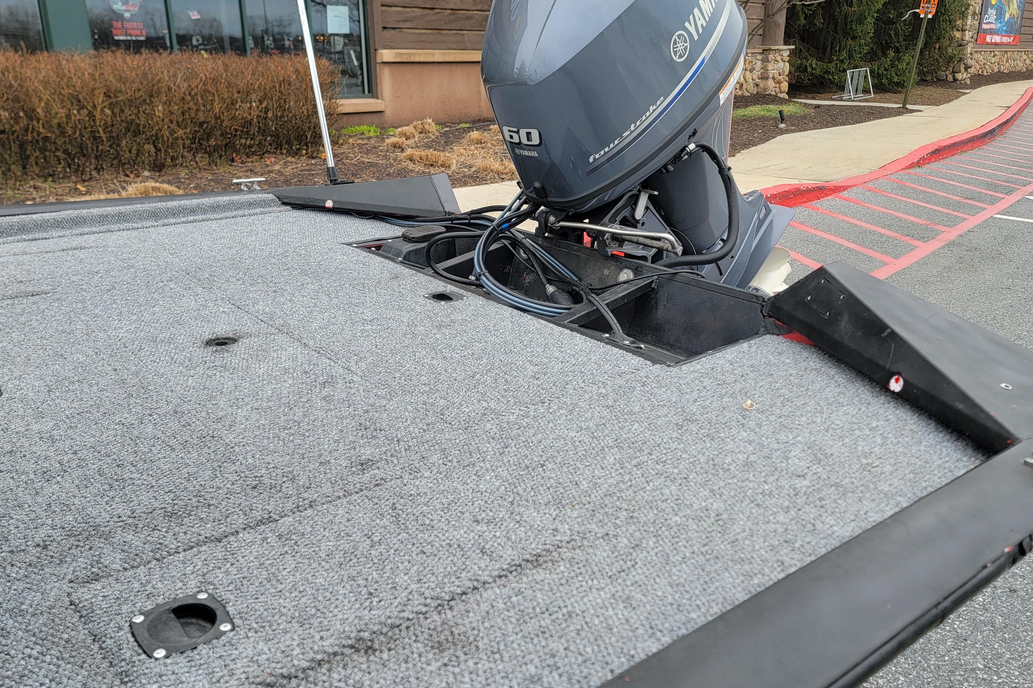 2006 Tracker Pro Team 190 TX boat with Yamaha outboard motor in parking lot.