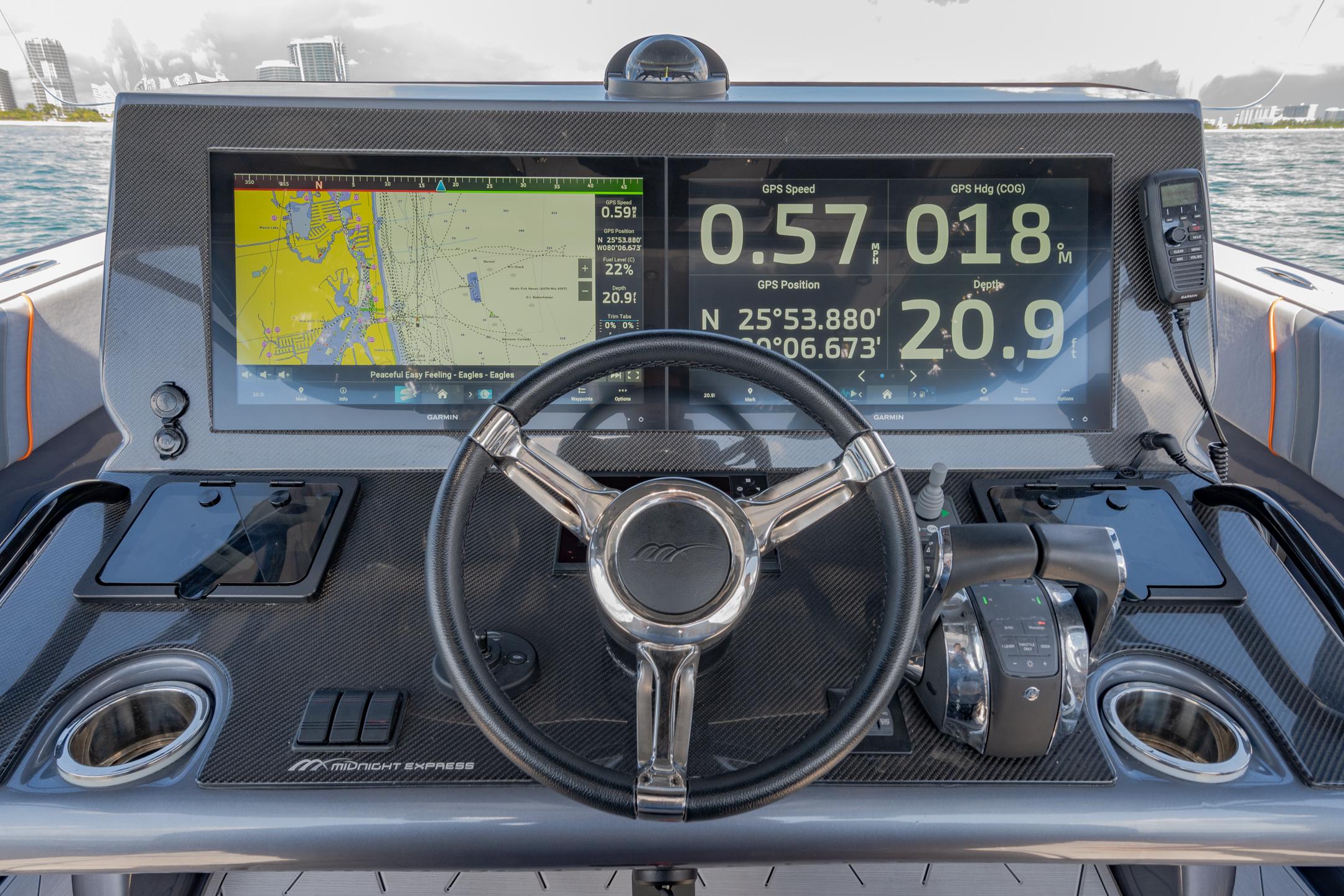 2022 Midnight Express 37' Open boat dashboard with navigation screens and steering wheel.
