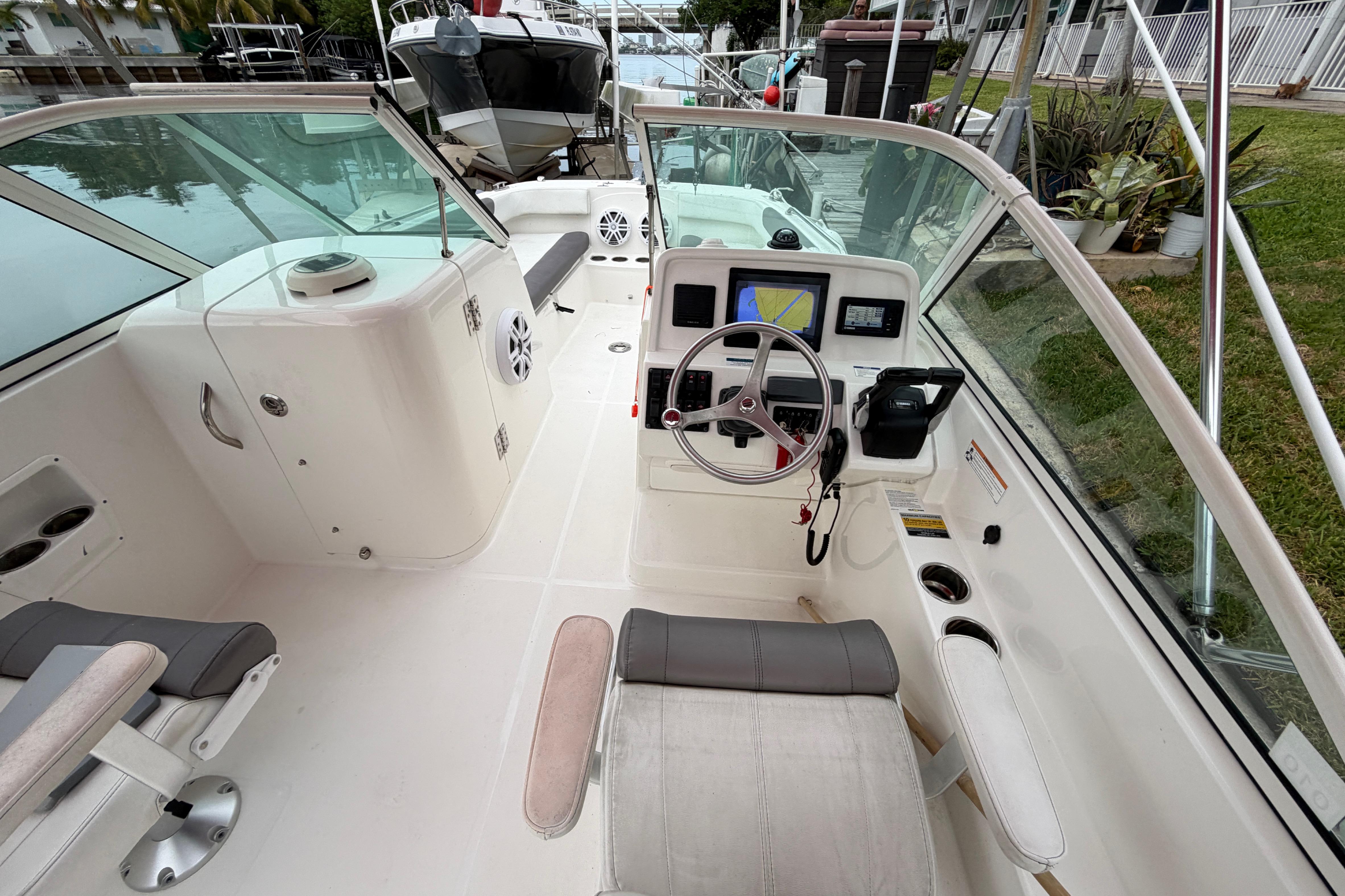 2019 World Cat 230 DC boat interior with steering console and seating.