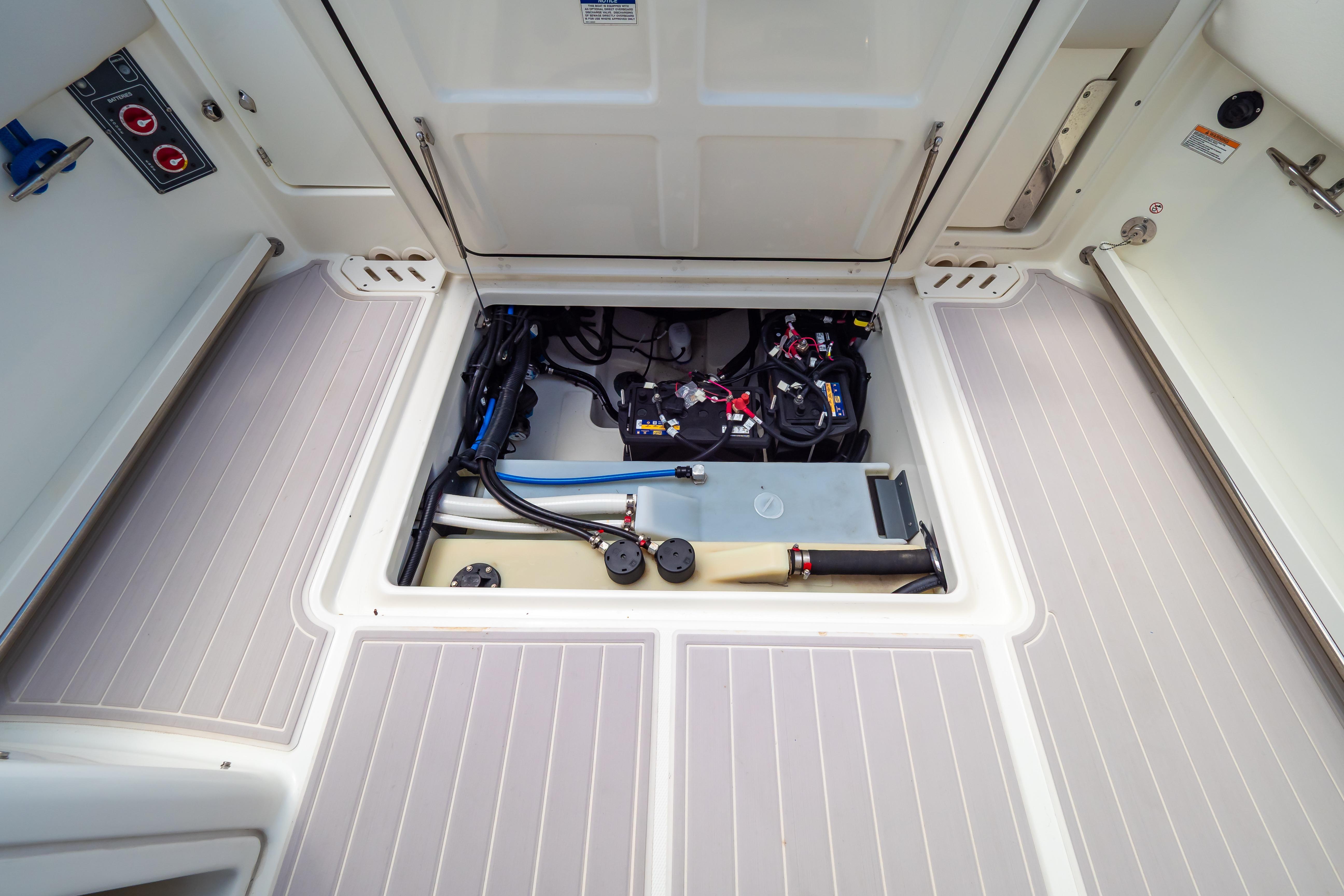 2019 Boston Whaler 270 Vantage boat storage compartment with visible wiring and equipment.