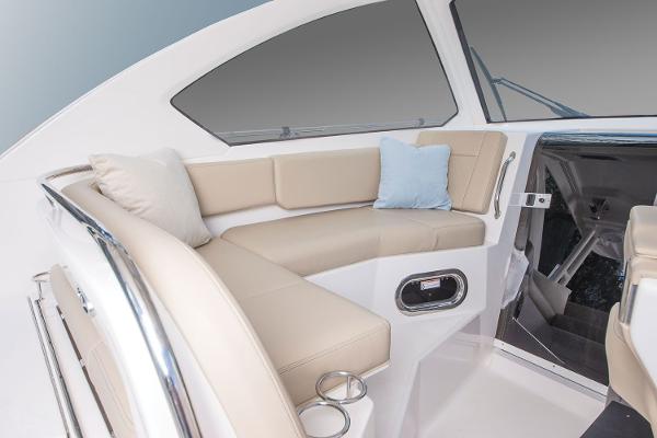 Manufacturer Provided Image: Interior seating area of 2021 Pursuit OS 325 Offshore boat with beige cushions.