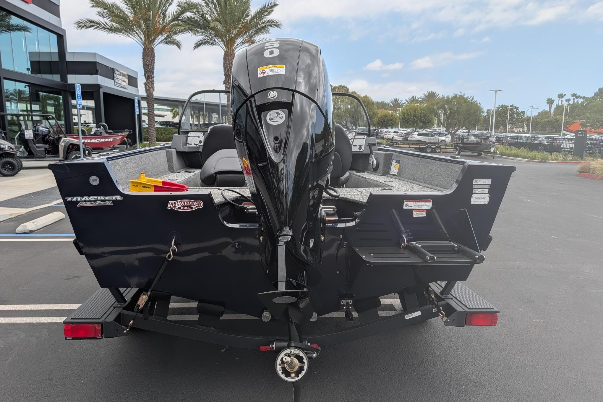 2026 Tracker Pro Guide V-175 WT boat with outboard motor, parked outdoors.