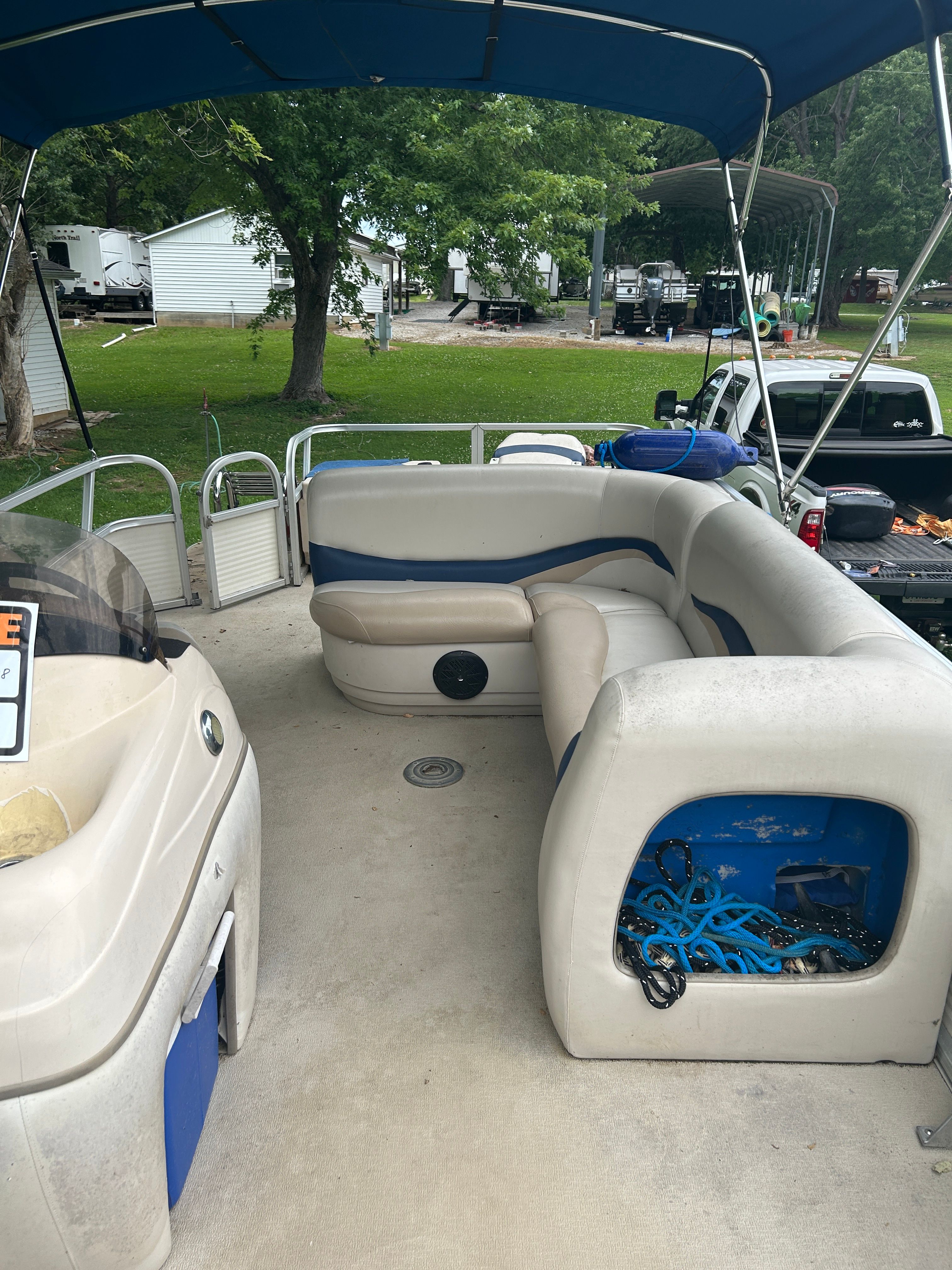 Interior view of a 2008 Sun Tracker Fishin' Barge 21' with seating and storage.
