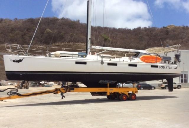 Sundeer 56 sailboat from 1994 on a trailer, set against a mountainous backdrop.