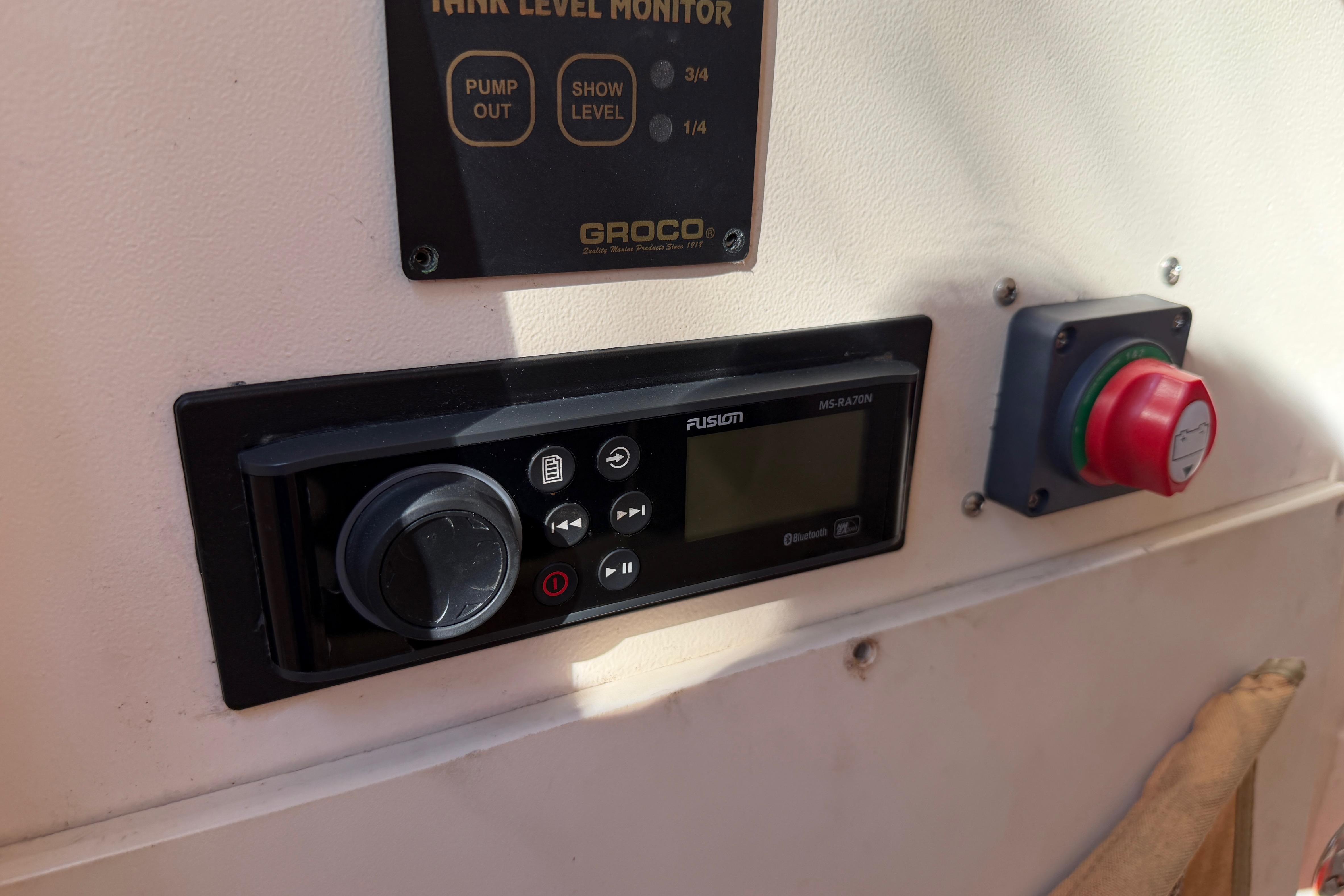 Control panel on 2004 Grady White 273 boat with Fusion audio system and tank level monitor.
