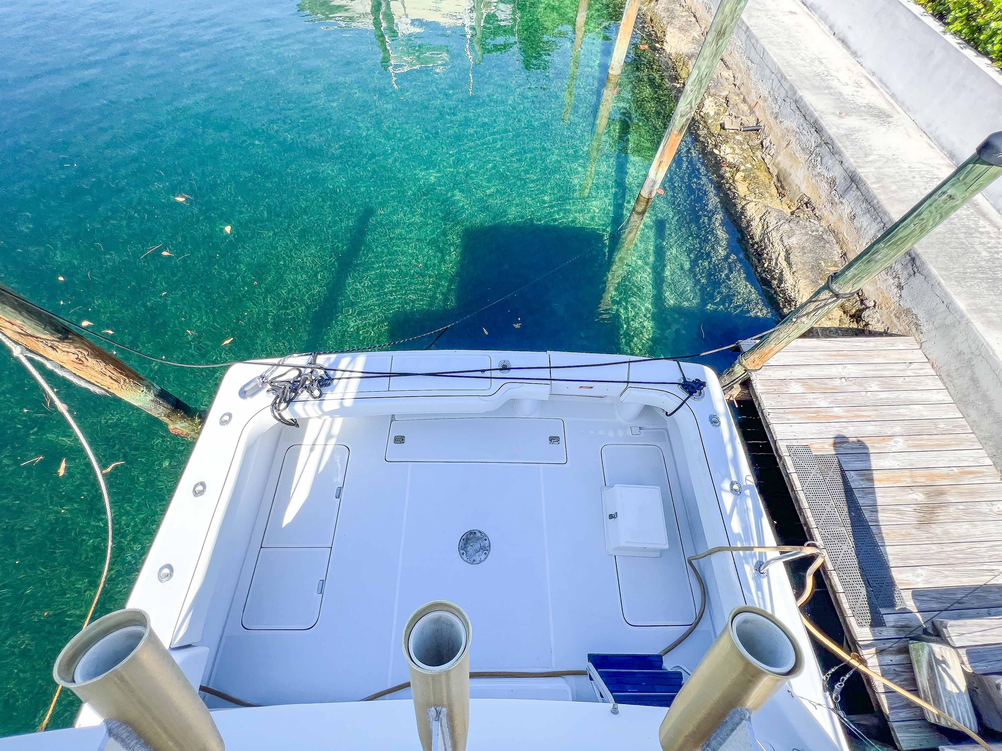 2000 Luhrs 400 Convertible boat docked at a clear water marina.