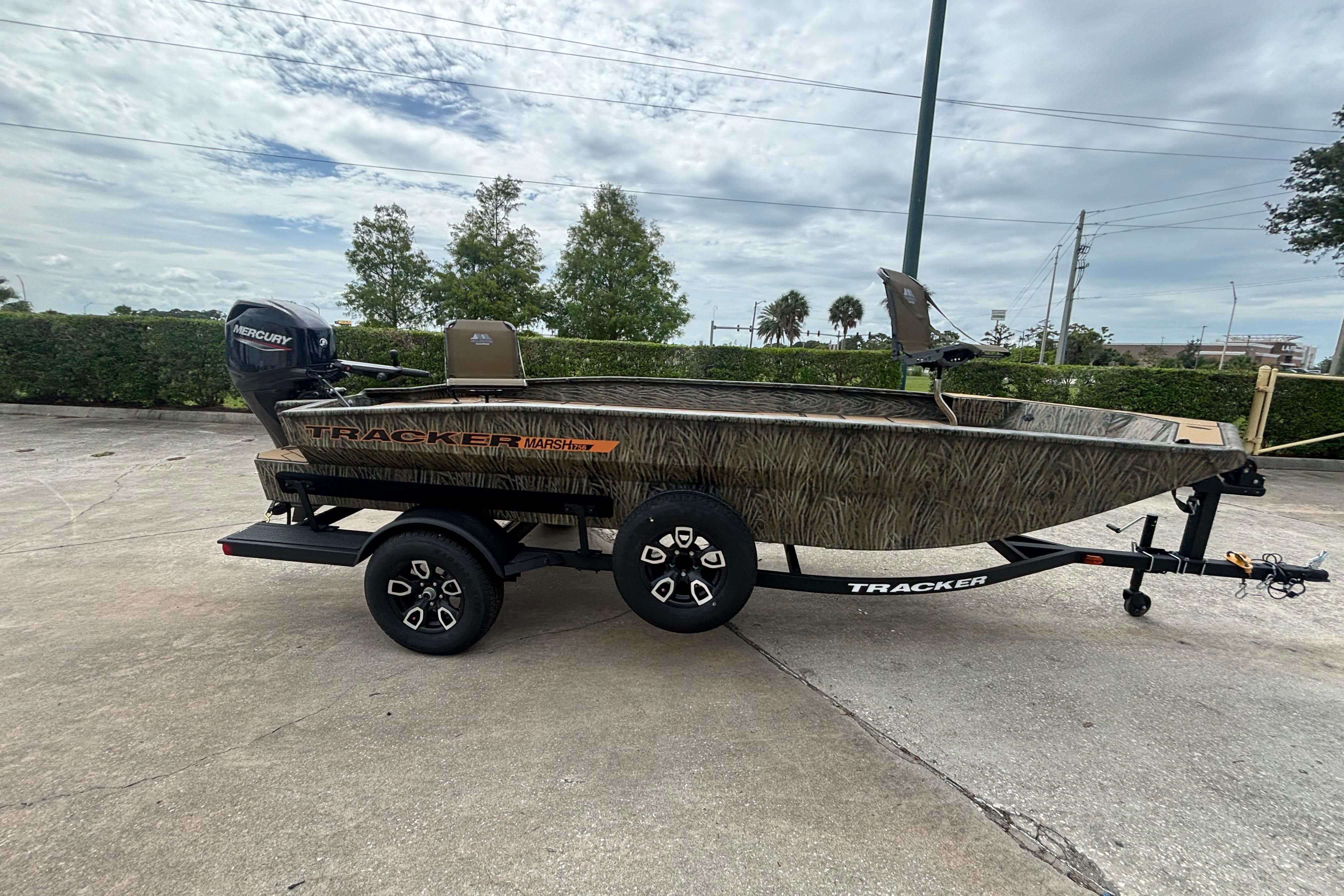2026 Tracker Grizzly 1756 T Marsh boat on trailer, outdoors, with Mercury engine.