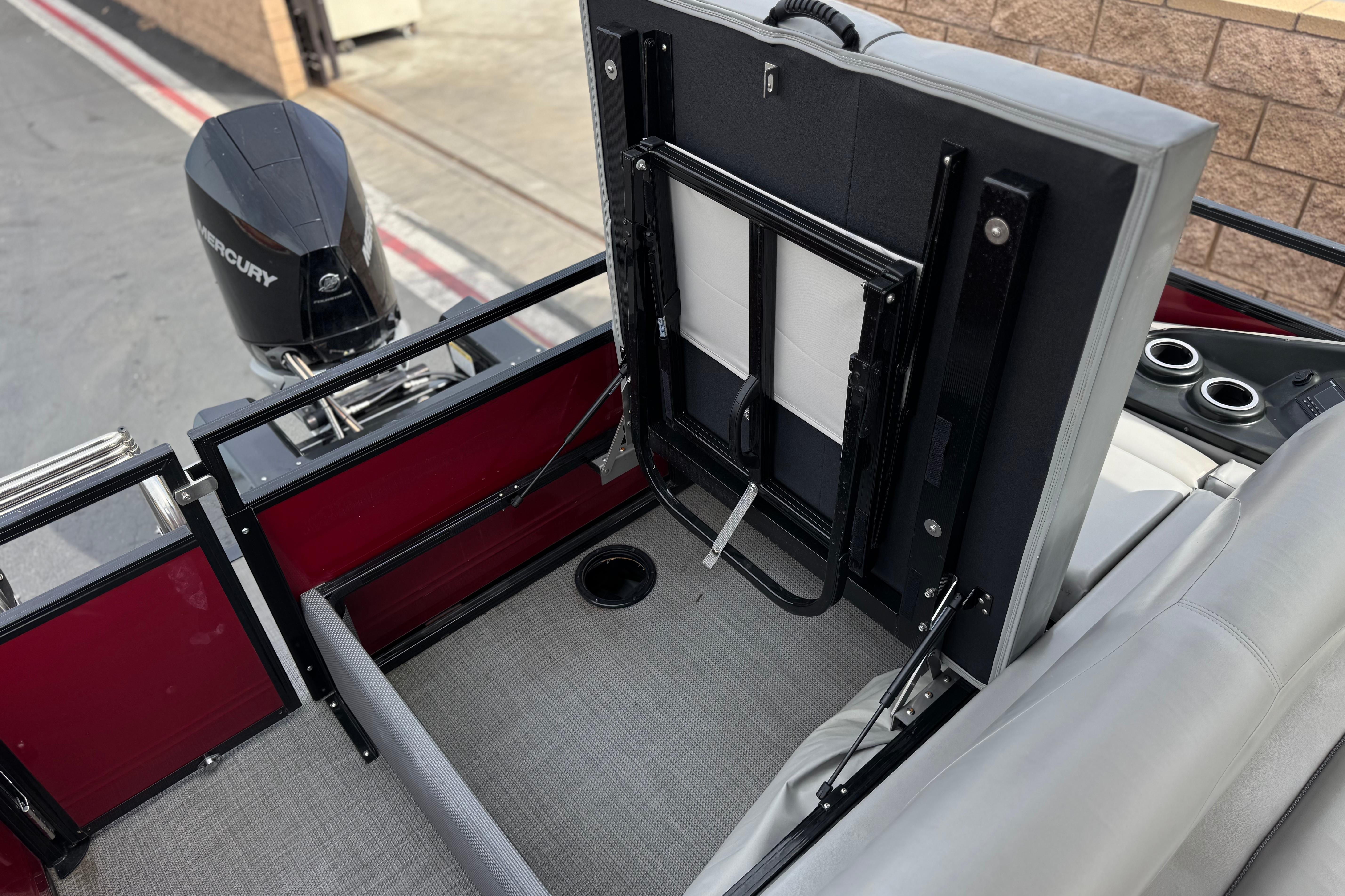 2022 Regency 250 DL3 boat interior with Mercury engine, featuring foldable seating and cup holders.