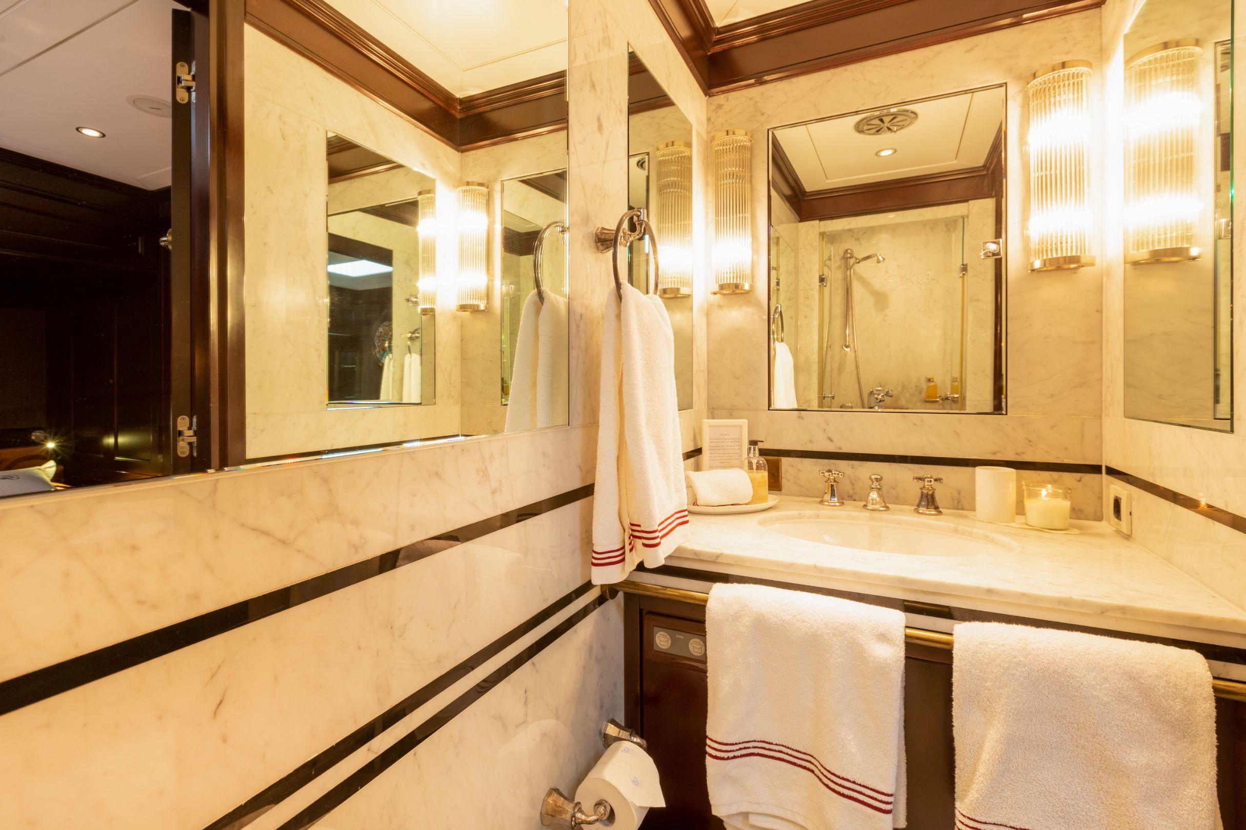 Luxurious bathroom on 2009 Mengi Yay Schooner yacht with marble accents and elegant lighting.