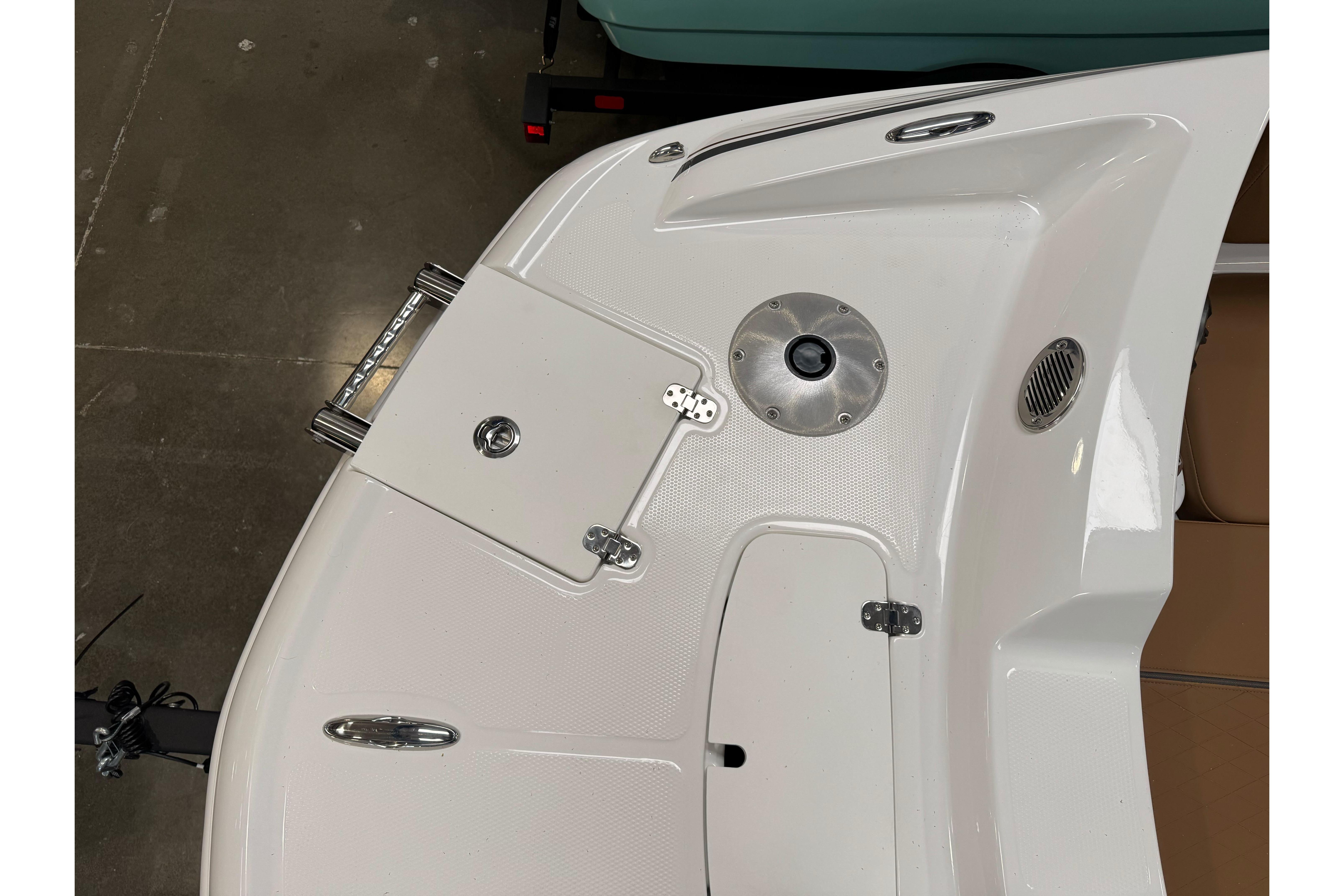 2026 Tahoe 2150 boat deck with storage hatch and stainless steel fittings.