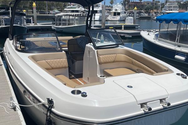 2024 Bayliner DX 2250 boat docked, featuring spacious seating and sleek design.